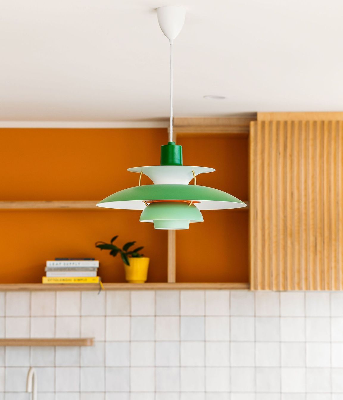 The replica PH5 lamp sits in perfect harmony with the mid-century inspired design and colour scheme.