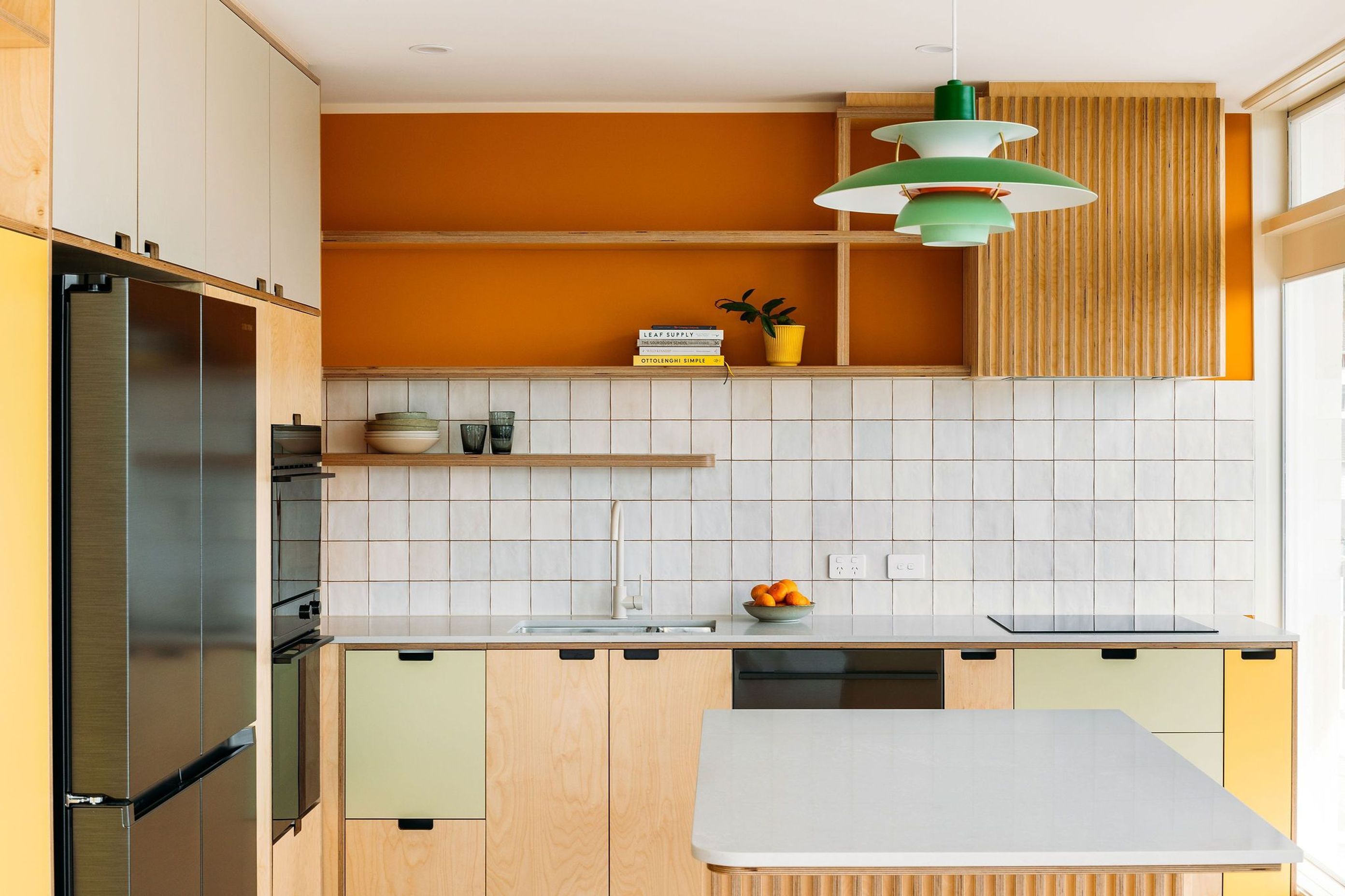 The island benchtop and cabinetry follow lovely radiused curves.