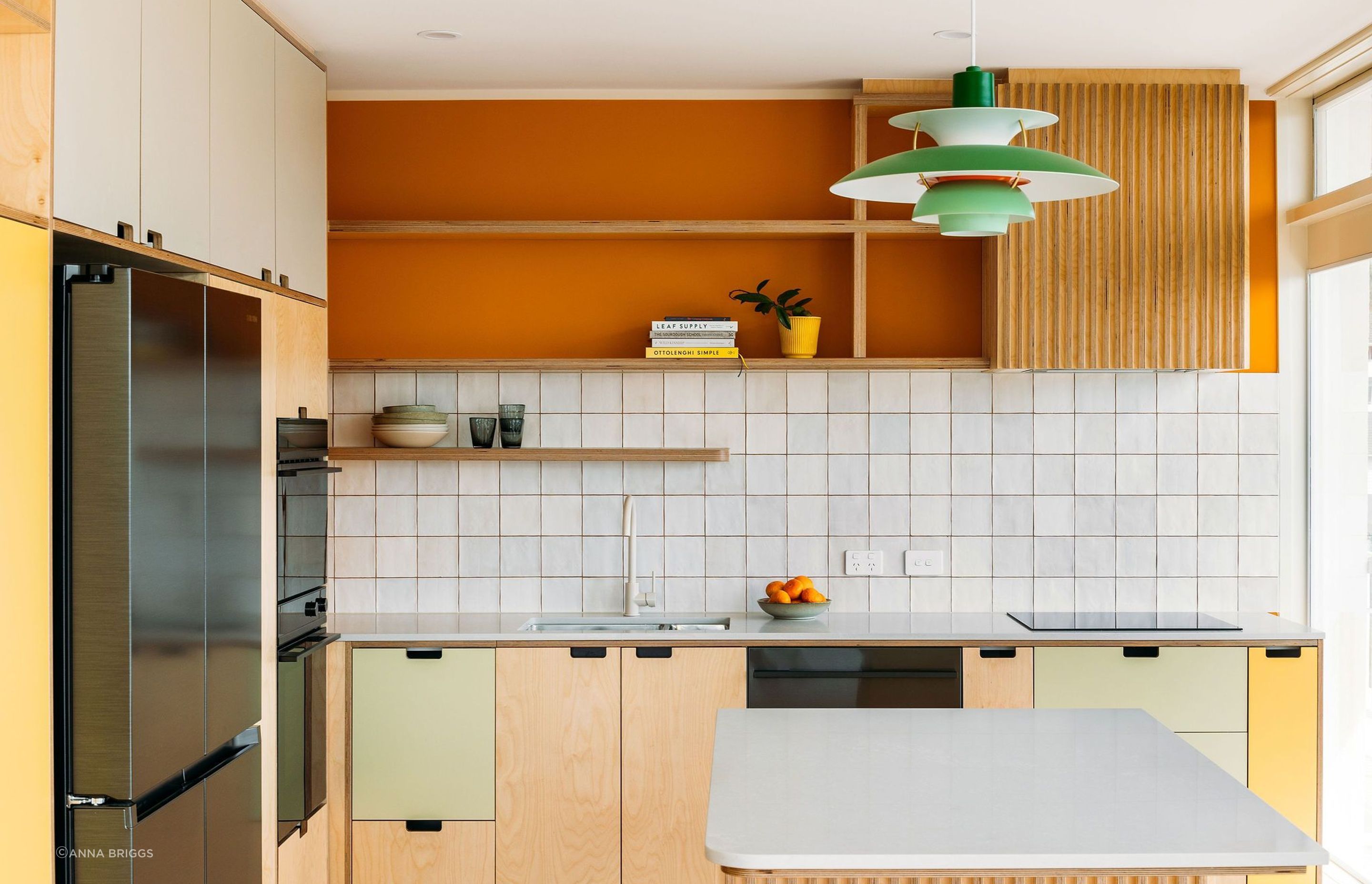 The island benchtop and cabinetry follow lovely radiused curves.