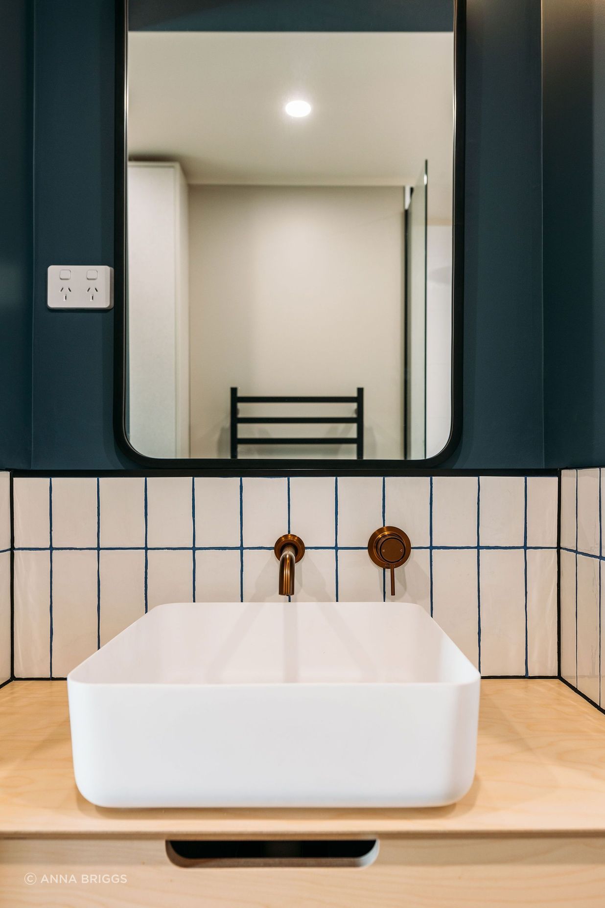 Gorgeous grout, copper tapware and plywood bring the materials palette into the bathroom.
