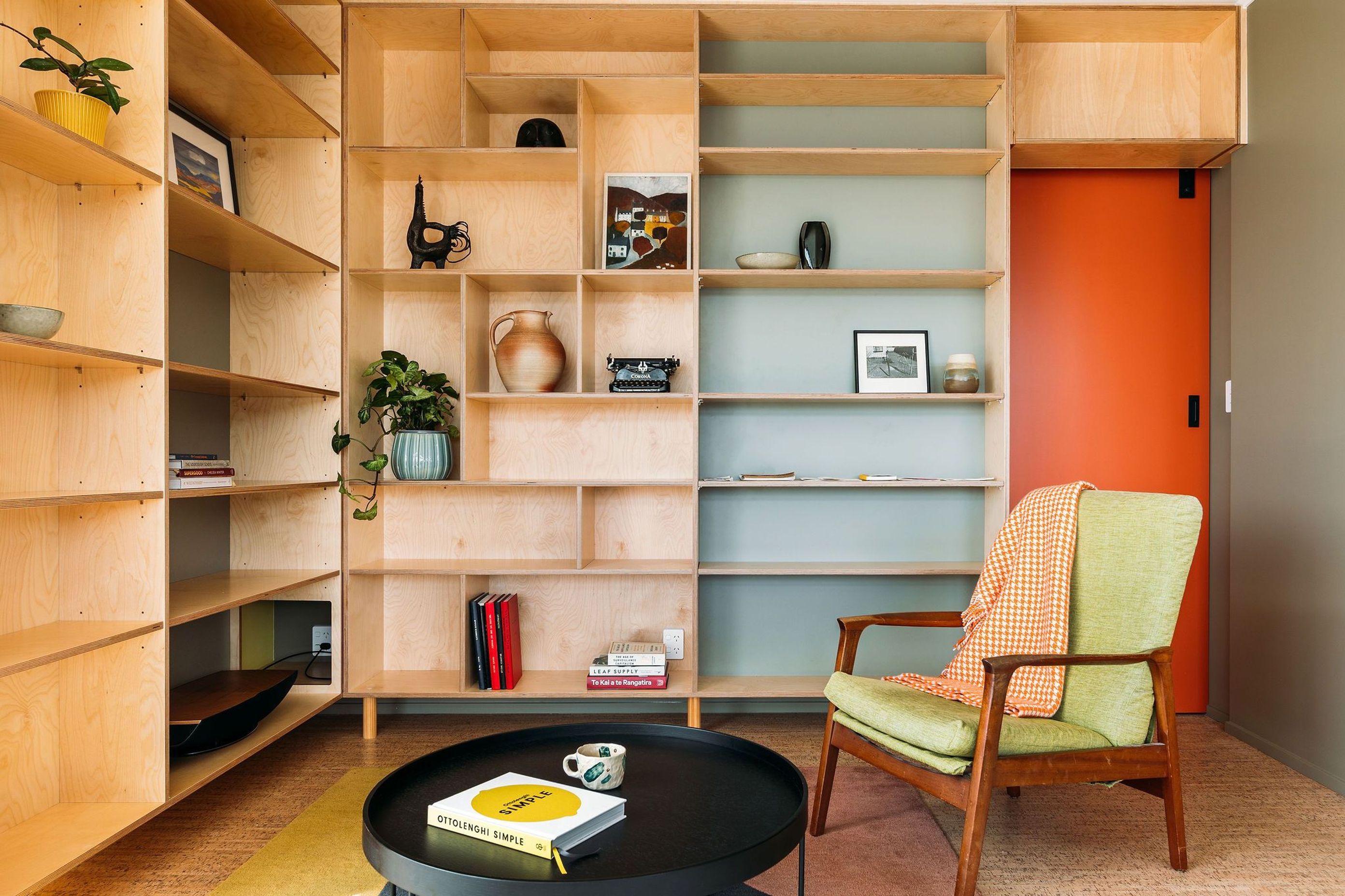 Colour, plywood and adjustable shelves have been utilised in the living room. A cut out for internet and AV services was also accommodated here.