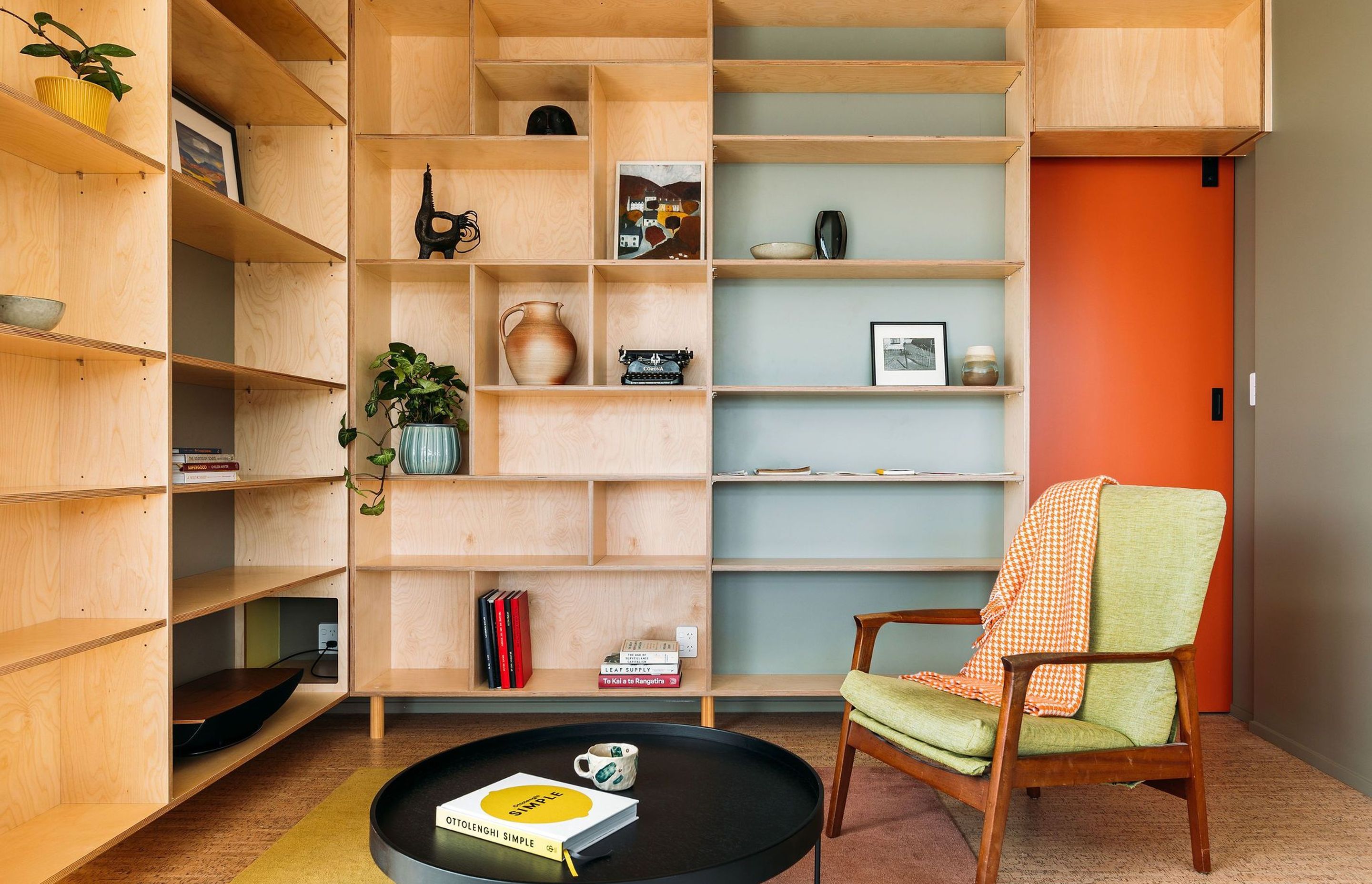 Colour, plywood and adjustable shelves have been utilised in the living room. A cut out for internet and AV services was also accommodated here.