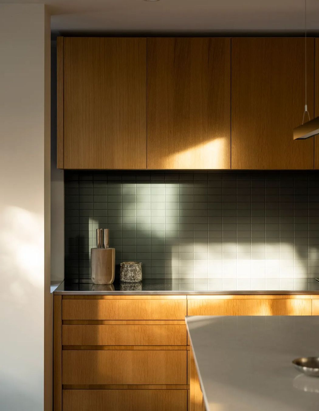 The kitchen receives morning and evening light and is the heart of the open-plan living area.