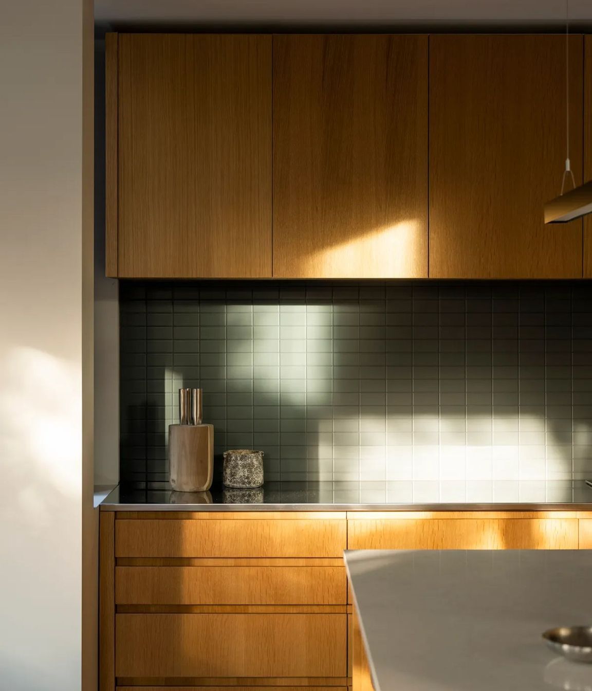 The kitchen receives morning and evening light and is the heart of the open-plan living area.
