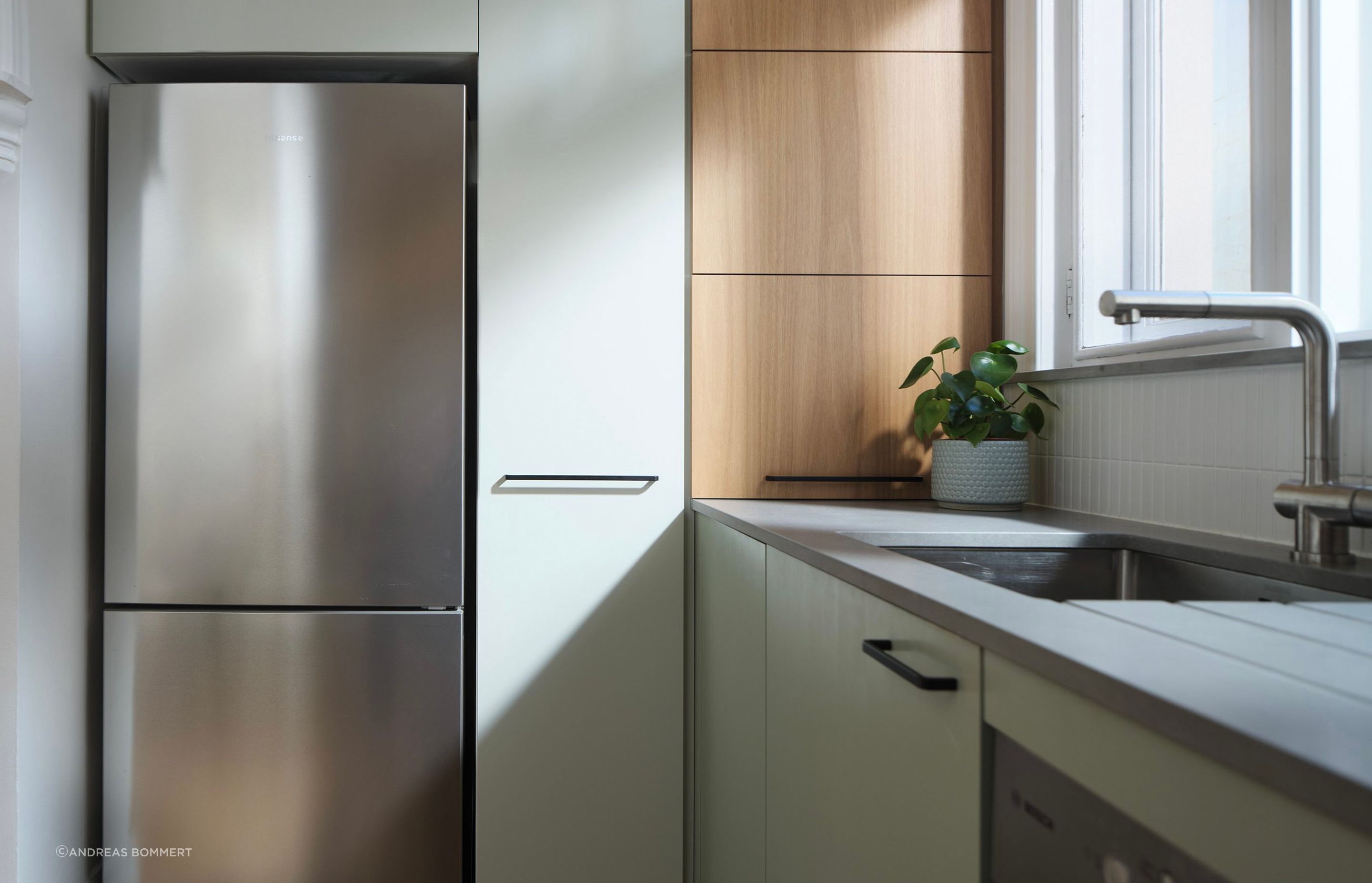 We created a mix of hand painted light green doors to break up and provide contrast against Blackbutt veneer panels.