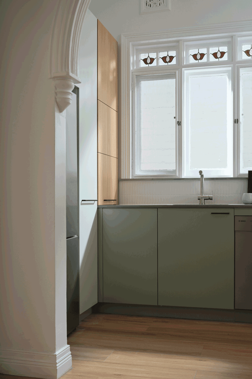 Blind corner baskets and a slide-out appliance shelf accessed by a lift-up door make the most of every nook of this kitchen.