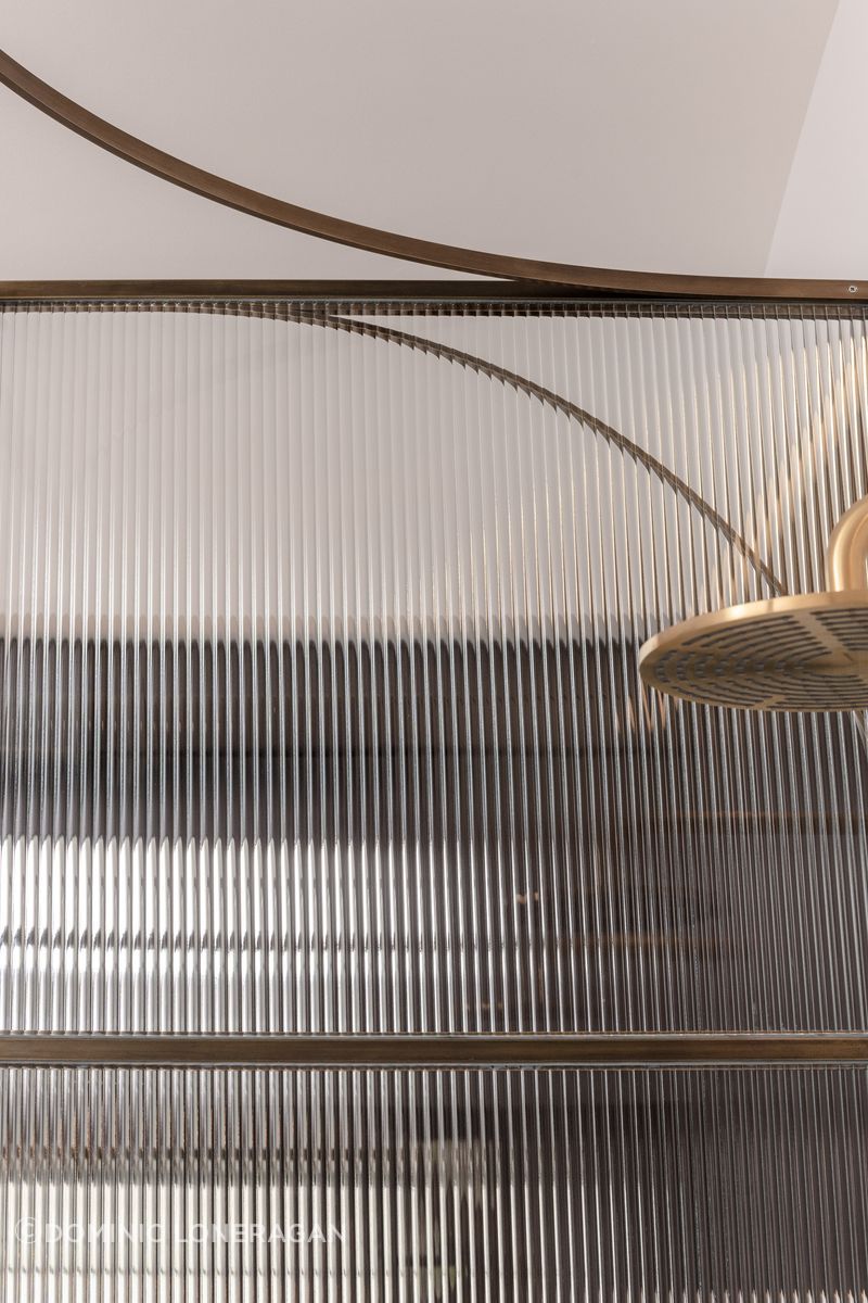 Curved brass and fluted glass details
