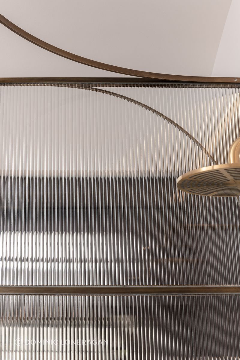 Curved brass and fluted glass details