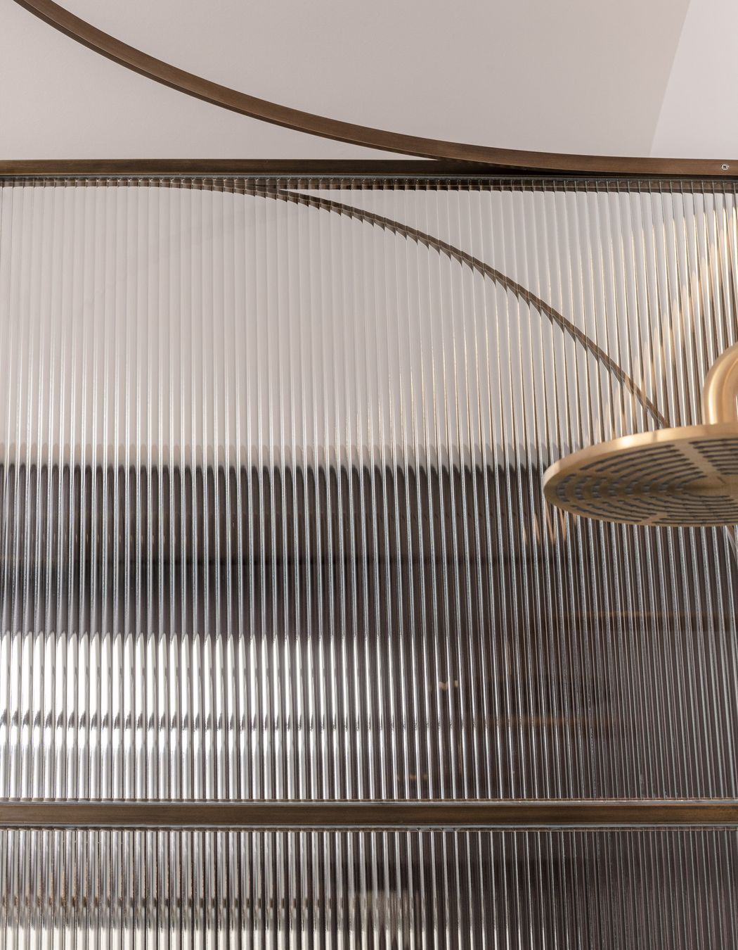 Curved brass and fluted glass details