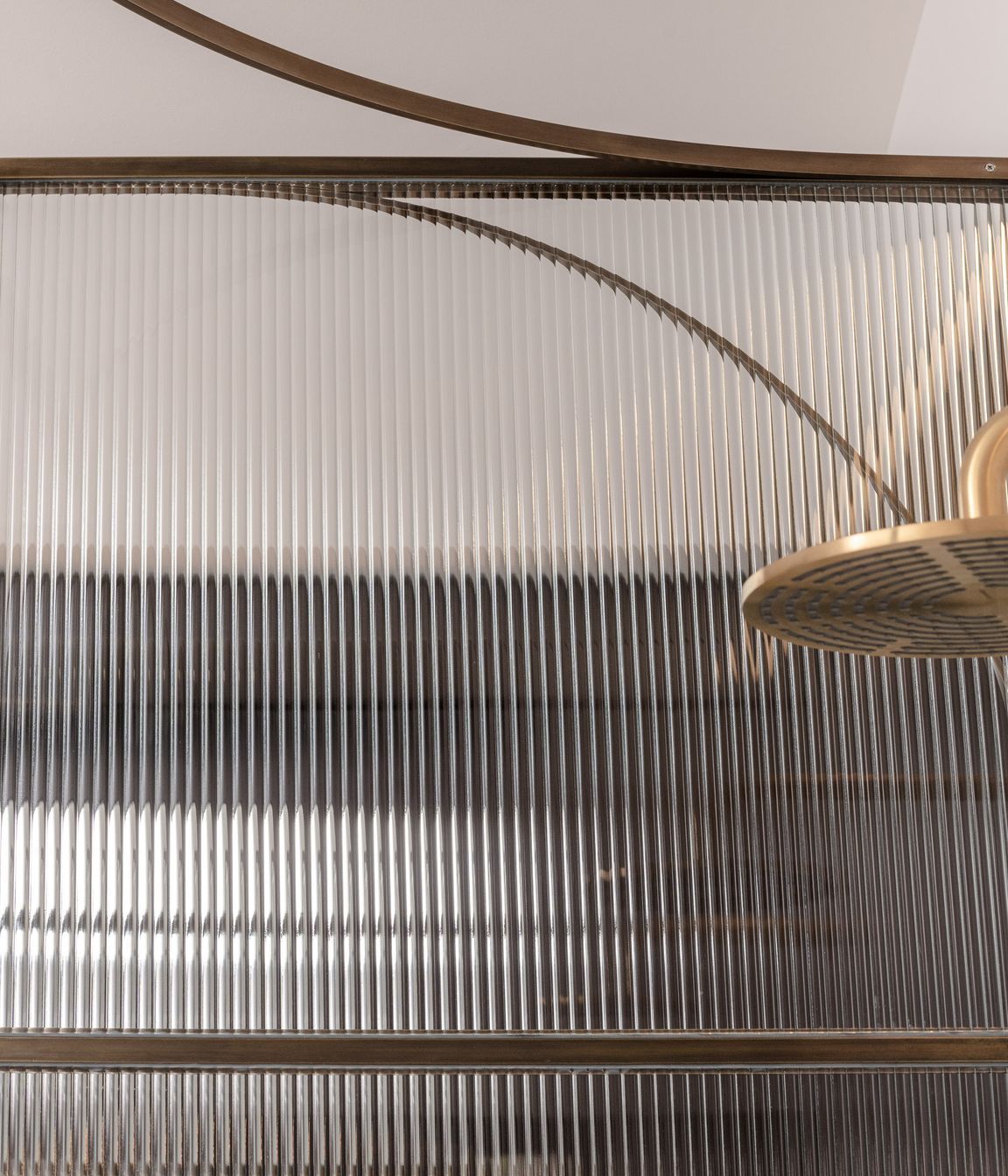 Curved brass and fluted glass details