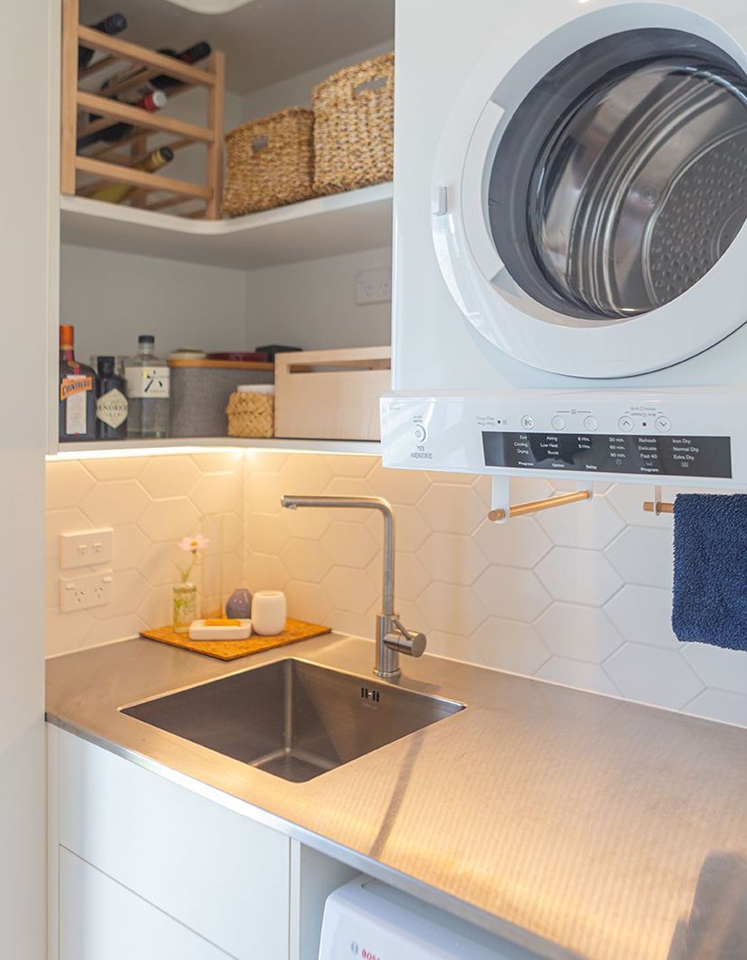 Stainless steel bench and inset sink are clean practical solutions in a laundry or scullery.