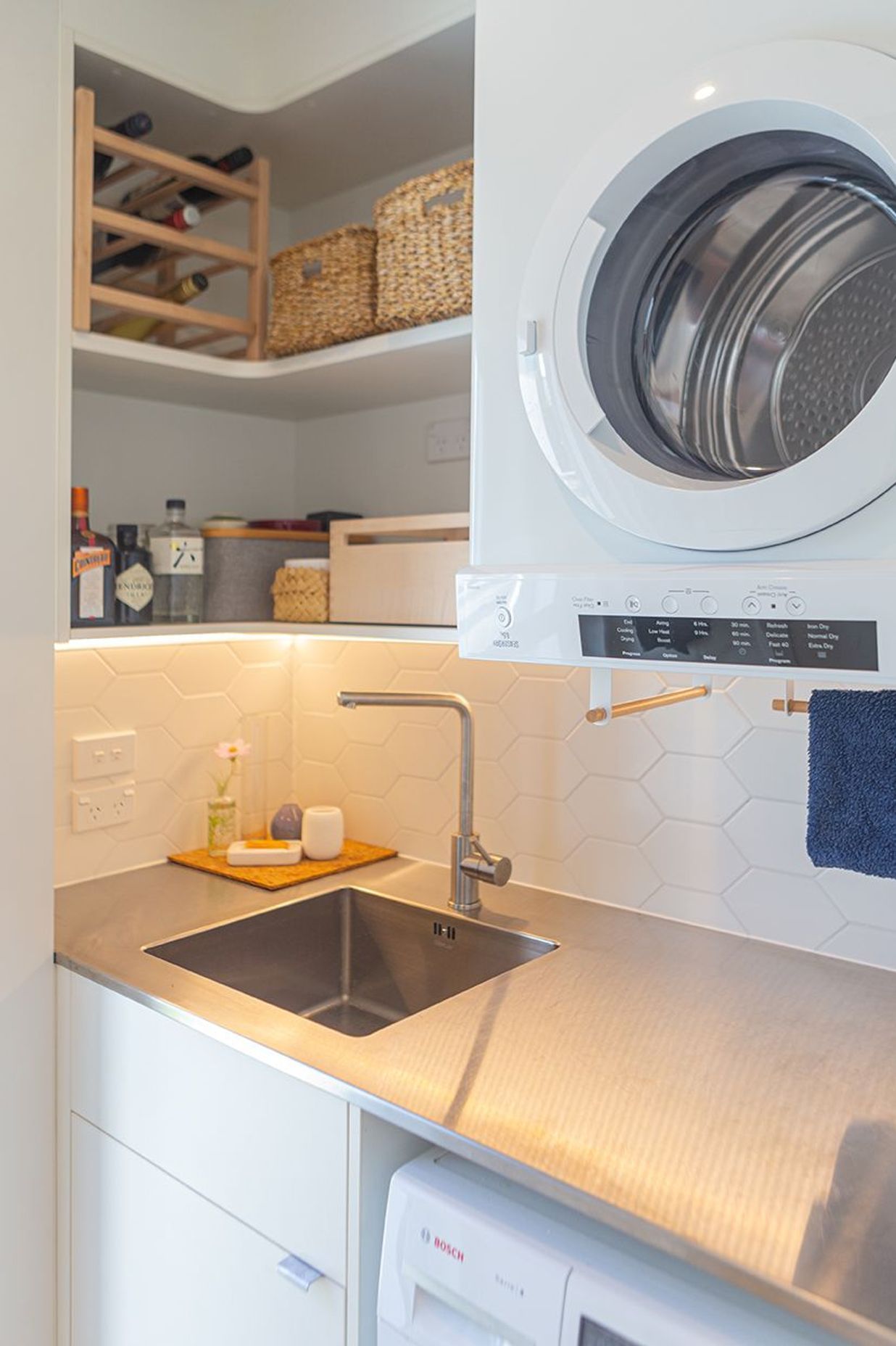 Stainless steel bench and inset sink are clean practical solutions in a laundry or scullery.