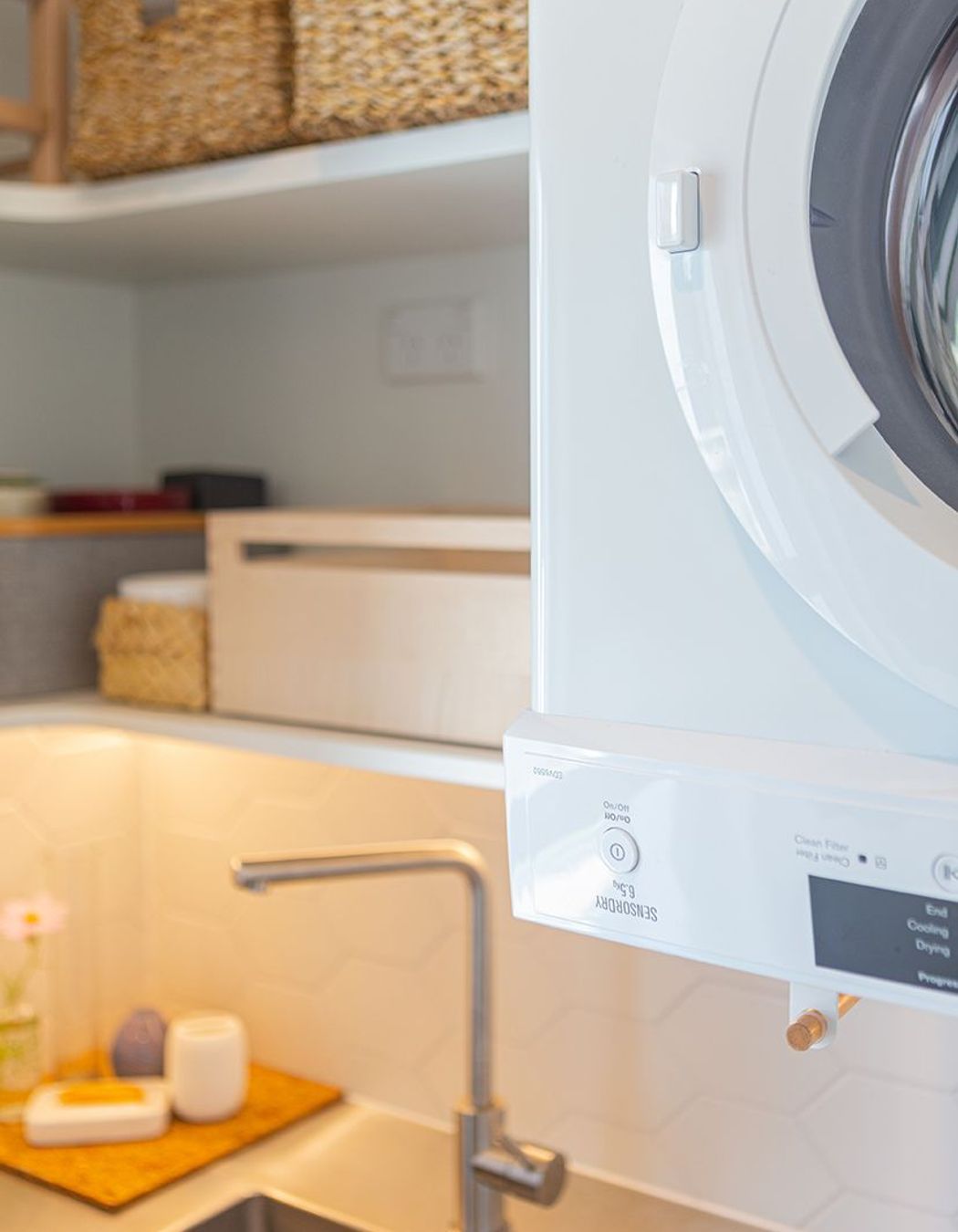 Wine storage, hanging space for cloths, power in the cabinetry - everything has been thought of in this small laundry.