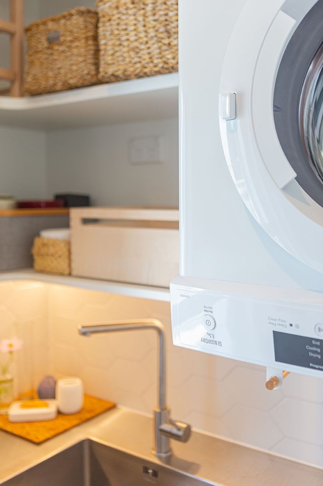 Wine storage, hanging space for cloths, power in the cabinetry - everything has been thought of in this small laundry.