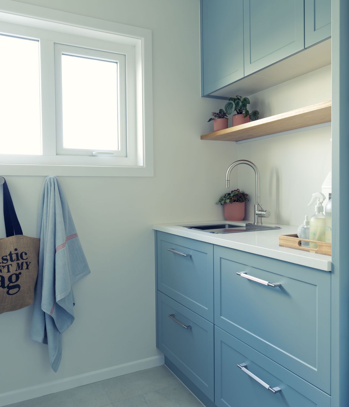 Small and functional laundry design with traditional design elements.