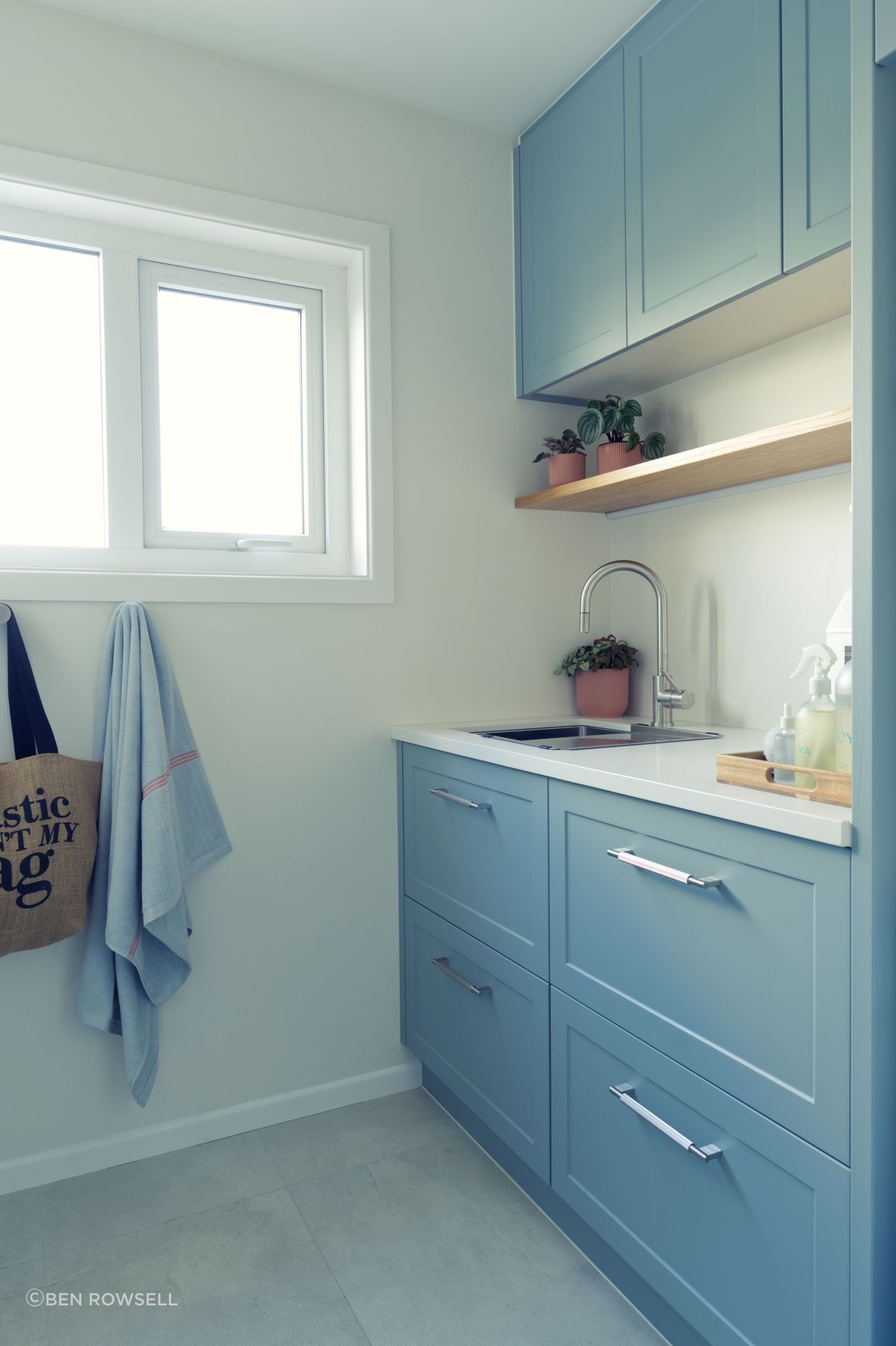 Small and functional laundry design with traditional design elements.