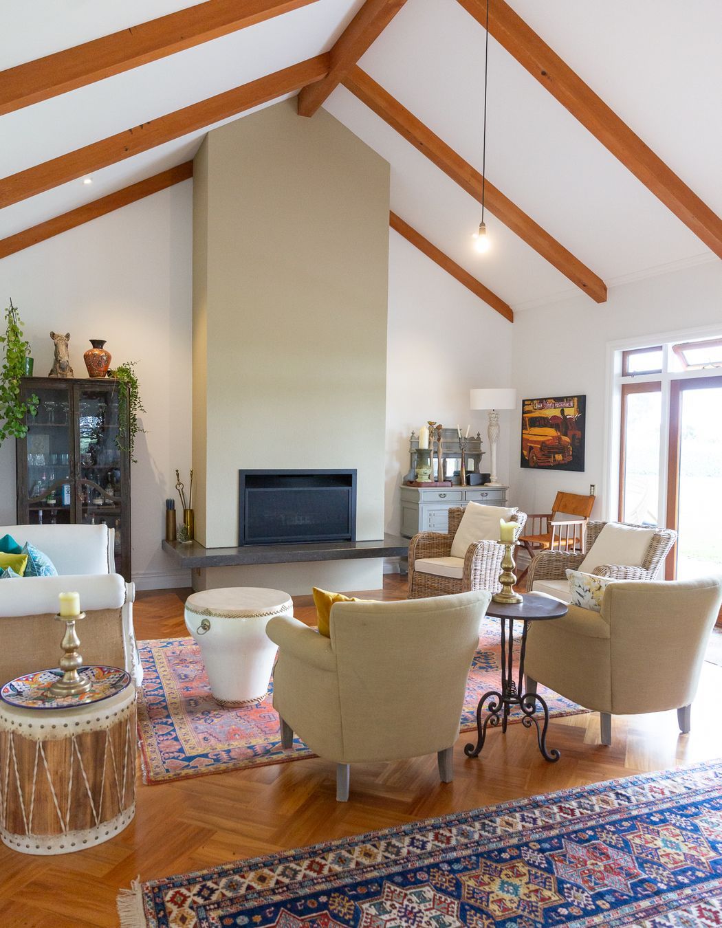 beautiful timber beams highlight the angles in the lounge room ceiling