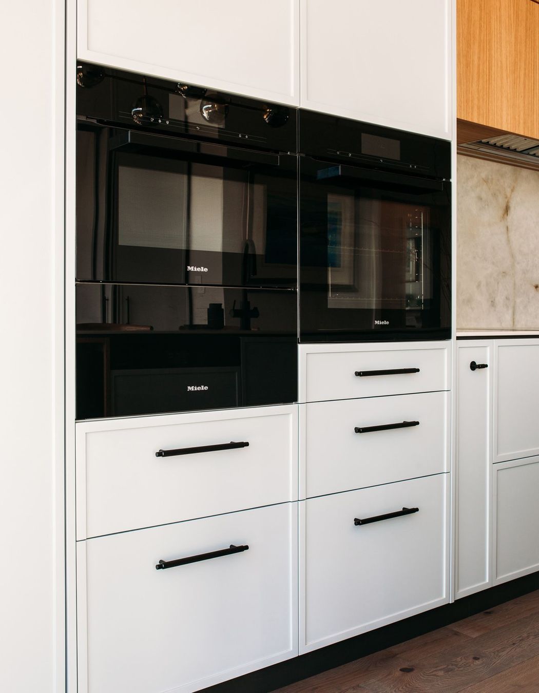 Careful planning of the kitchen cabinetry has resulted in a contemporary shaker style look.