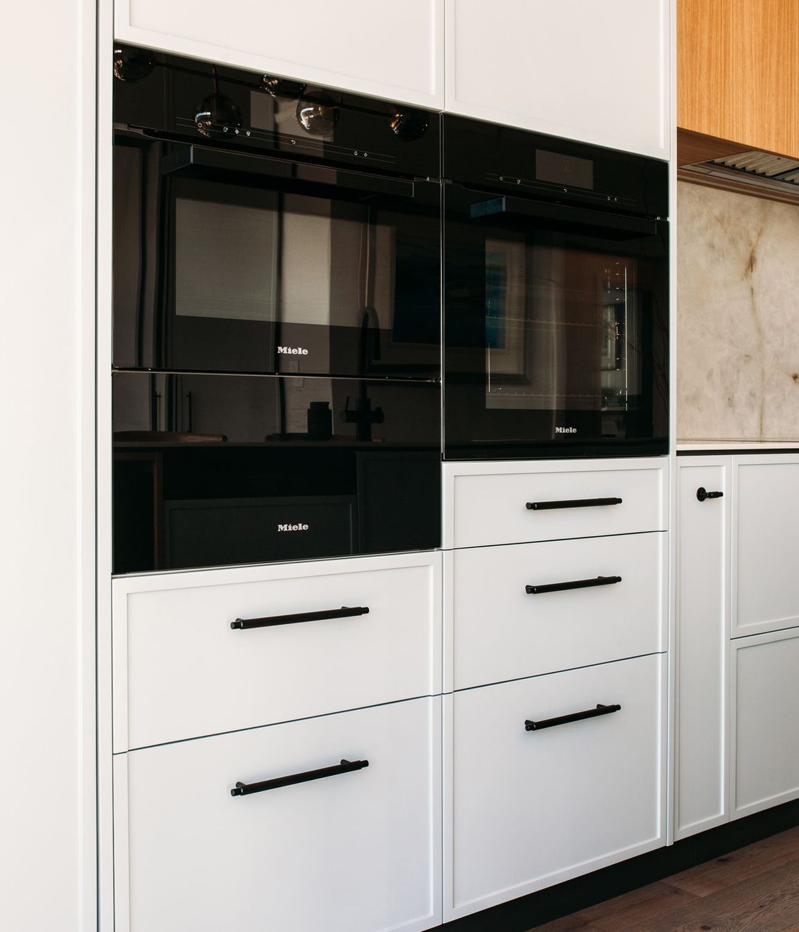 Careful planning of the kitchen cabinetry has resulted in a contemporary shaker style look.