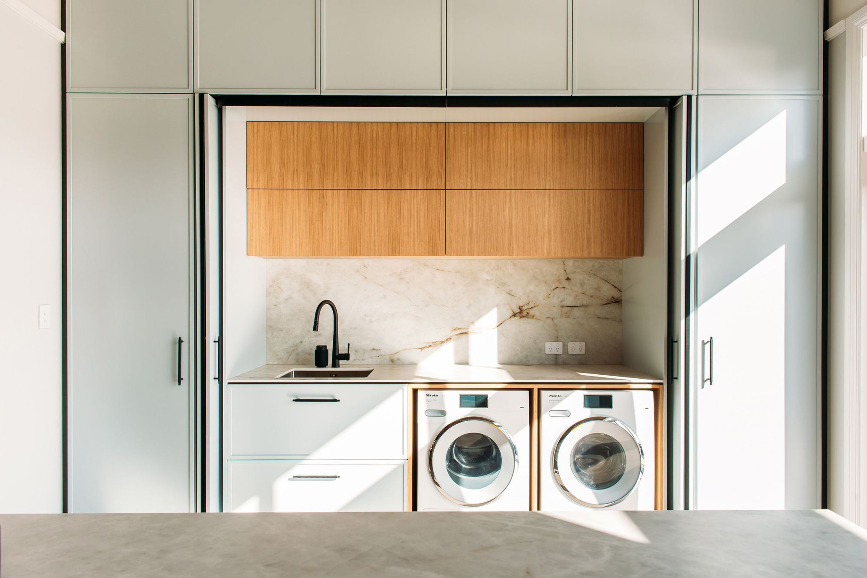 Lots of storage in this laundry, and a second sink and bench space.