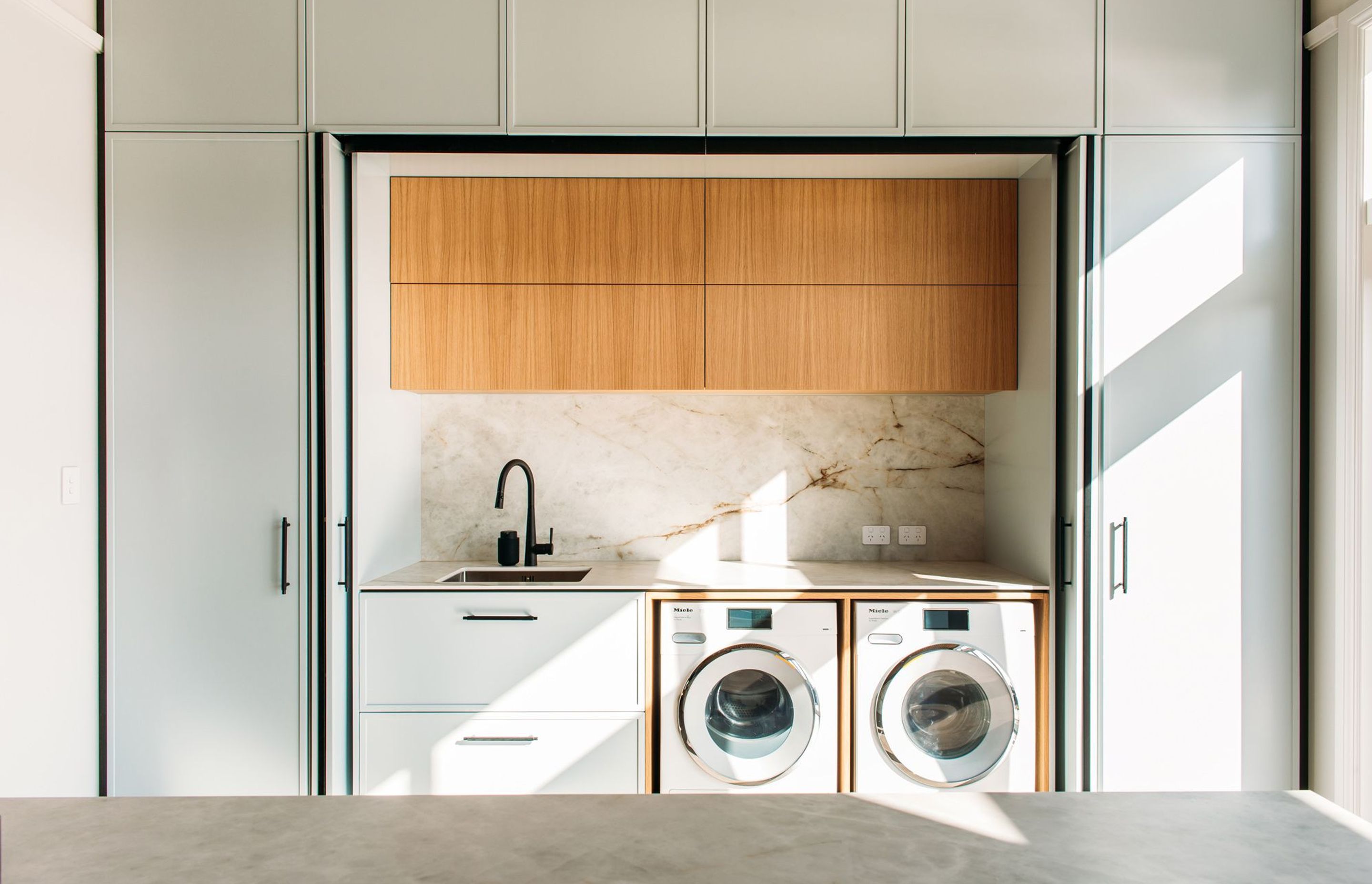 Lots of storage in this laundry, and a second sink and bench space.