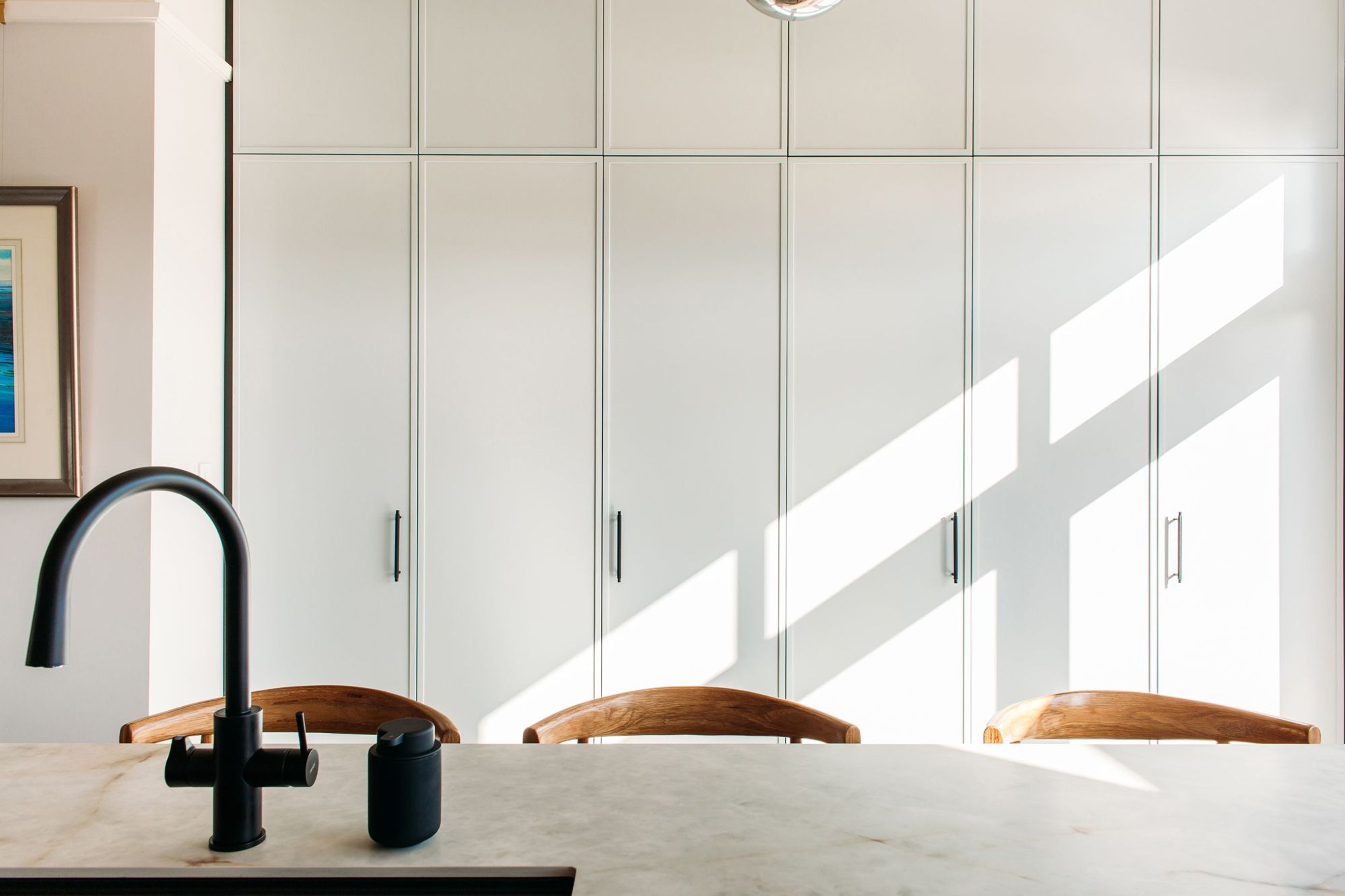 The laundry incorporates Hafele pocket doors, which open to reveal the laundry.