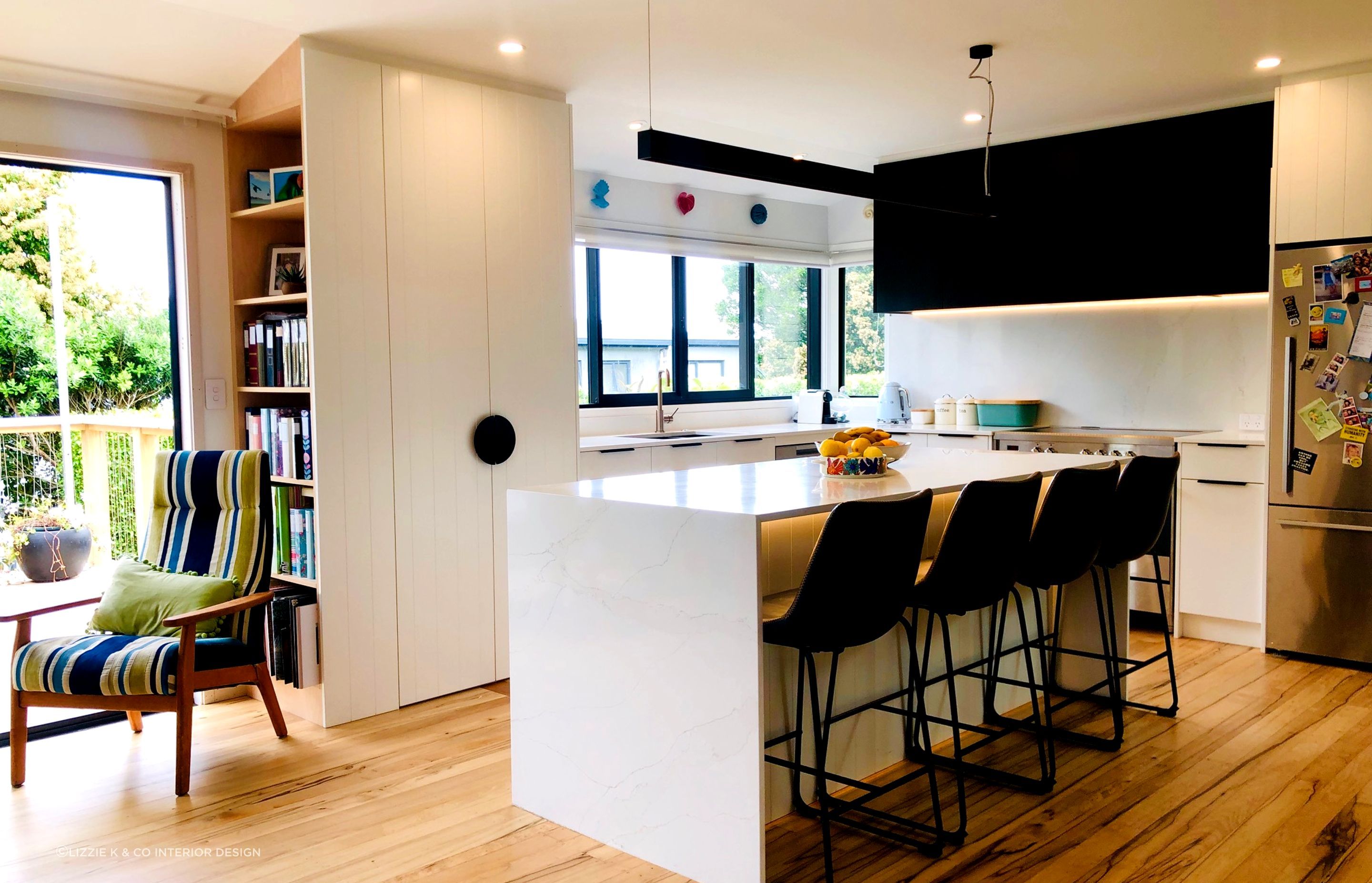 LIZZIE K & CO - Central Island for prep, serving & casual dining. Built in library shelving at end of food pantry.
