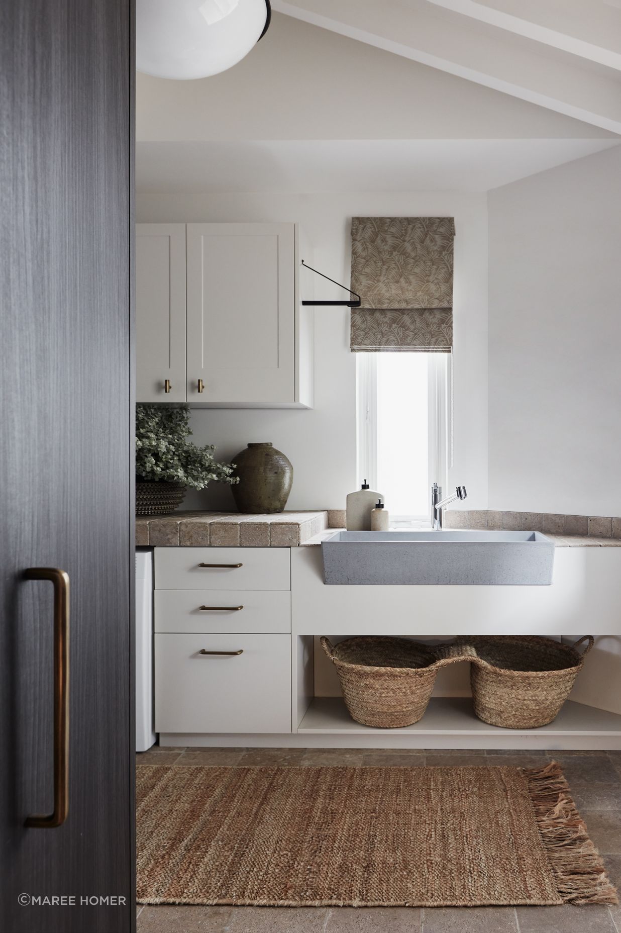LAUNDRY Walls and benchtop in dark travertine tumbled cobbles, Aeria Country Floors. Joinery in Eveneer Shou Sugi Ban veneer, Elton Group. Argent Esprit kitchen mixer, Arthaus. Henley handles, Hepburn Hardware. Sahara runner, Armadillo.