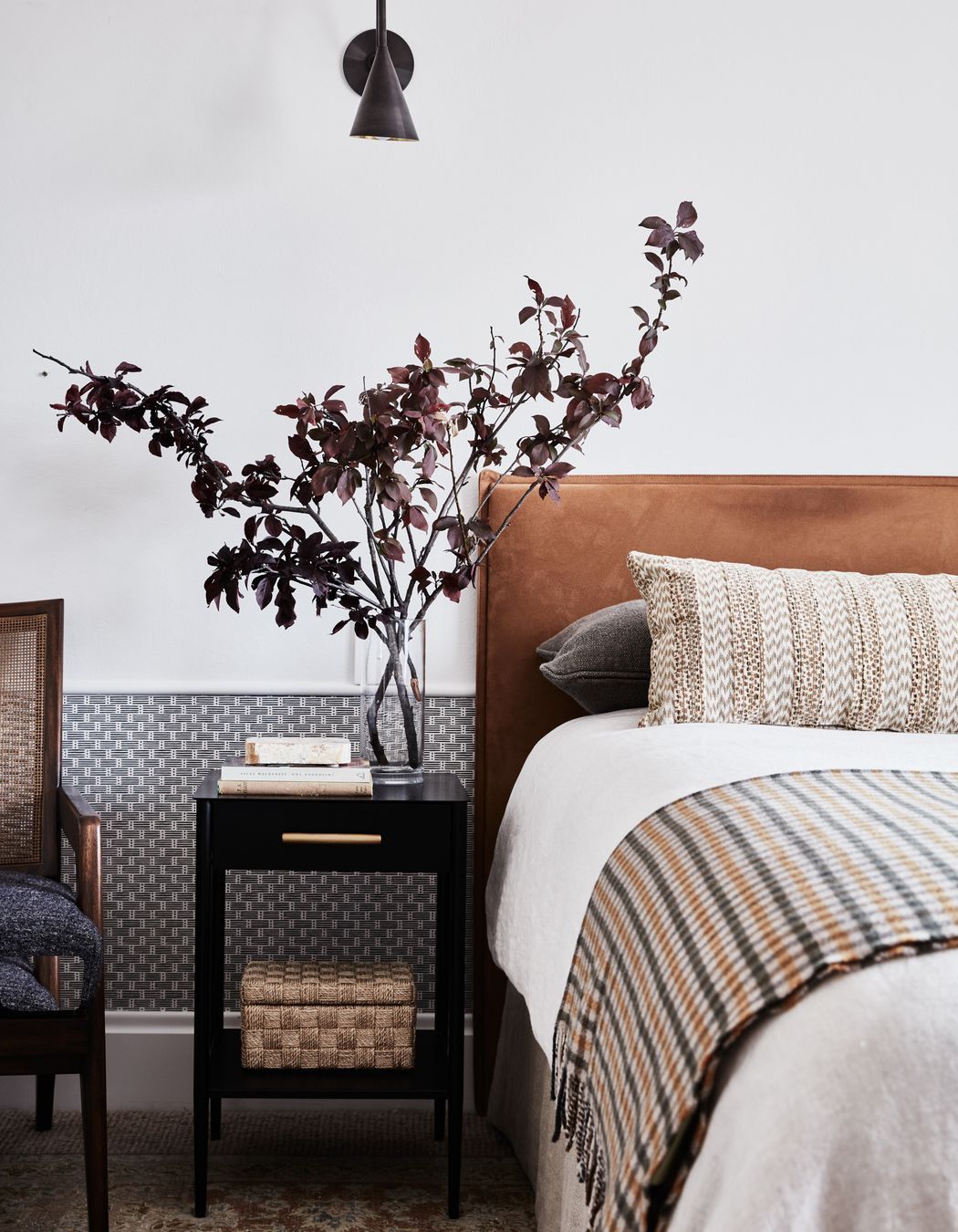 GUEST ROOM Schumacher ‘Dotted Stripe’ wallpaper, Orient House. Antique Persian Tabriz rug, Cadrys. Custom bedhead in Macrosuede Caramel, Warwick Fabrics. Bedlinen and throw, Kate Nixon. Metalwork nightstand, West Elm. Pinnacle sconce, Allied Maker.