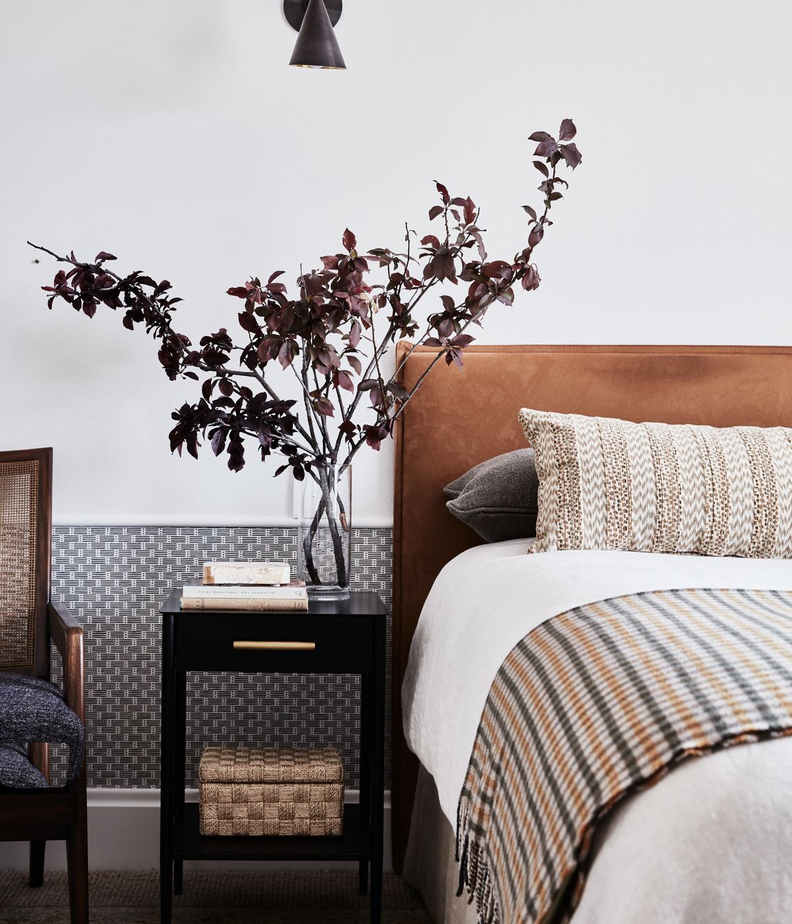 GUEST ROOM Schumacher ‘Dotted Stripe’ wallpaper, Orient House. Antique Persian Tabriz rug, Cadrys. Custom bedhead in Macrosuede Caramel, Warwick Fabrics. Bedlinen and throw, Kate Nixon. Metalwork nightstand, West Elm. Pinnacle sconce, Allied Maker.