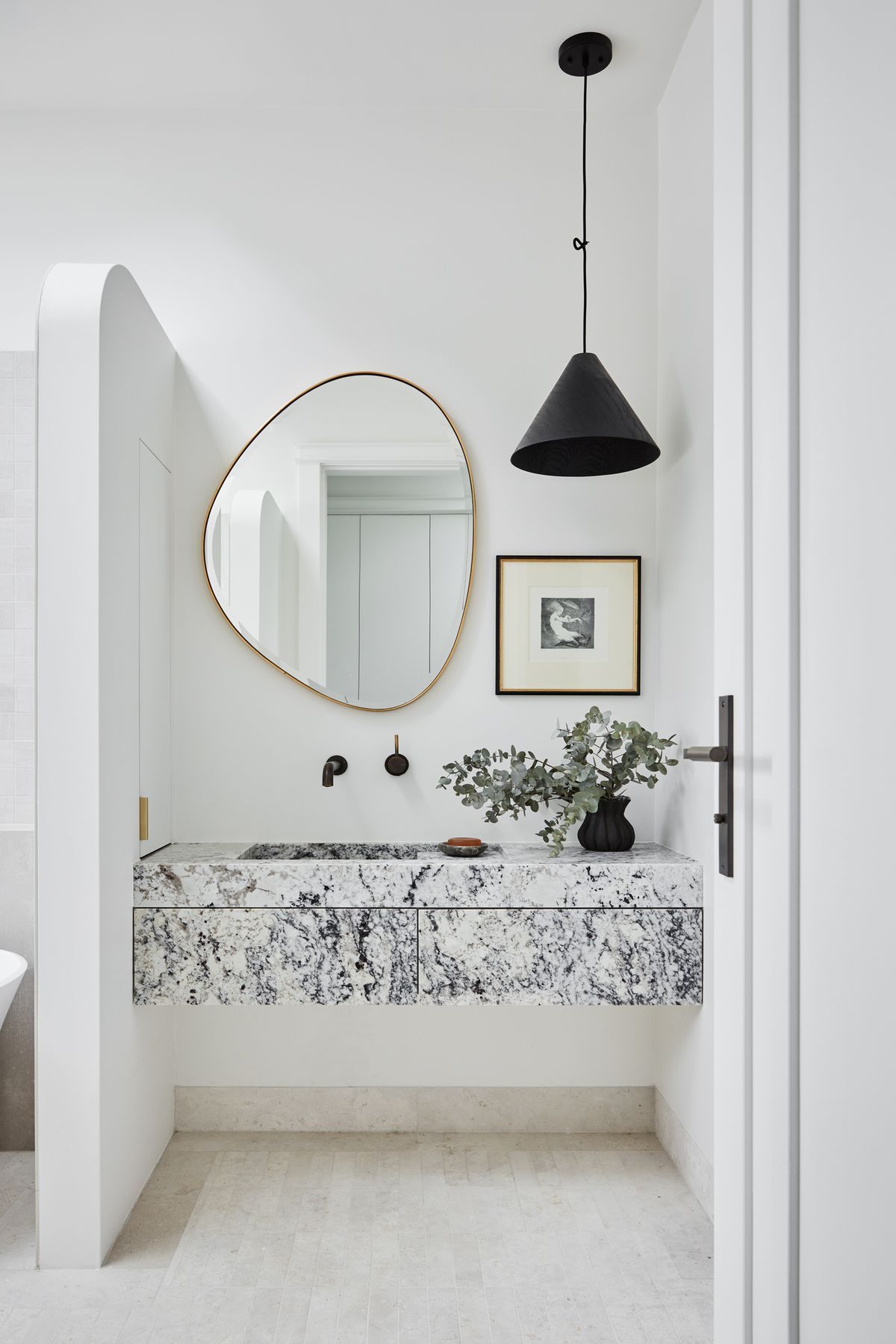 MAIN BATHROOM Summit 330 pendant light, About Space. Pebble mirror, Life Interiors. White granite vanity, Granite &amp; Marble Works. Brodware ‘City Stik’ wall mixer, Sydney Tap and Bathroomware. Limestone floor tiles, Onsite Supply+Design. Boost wall tiles, Rocks On.