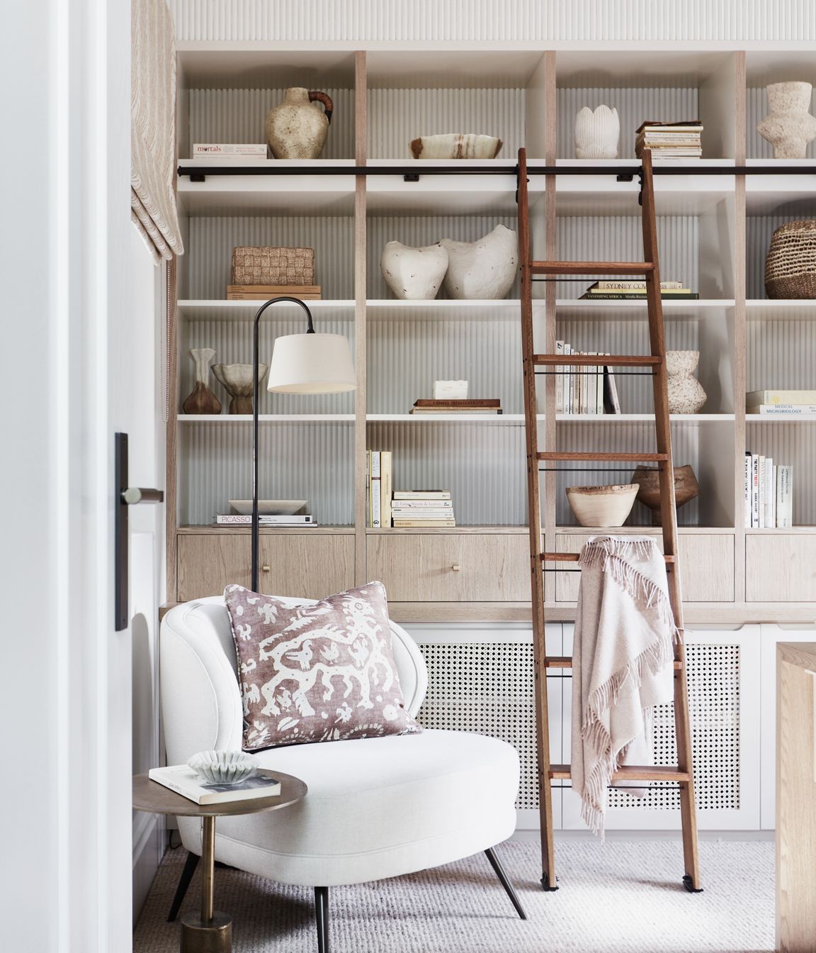 STUDY Library ladder, Ladder Central. Floor lamp, existing. Arteriors ‘Kitts’ armchair, Boyd Blue. Side table, Ideas 4 Lighting. Cushion in Lewis &amp; Wood ‘Iliad’ fabric, Elliott Clarke.