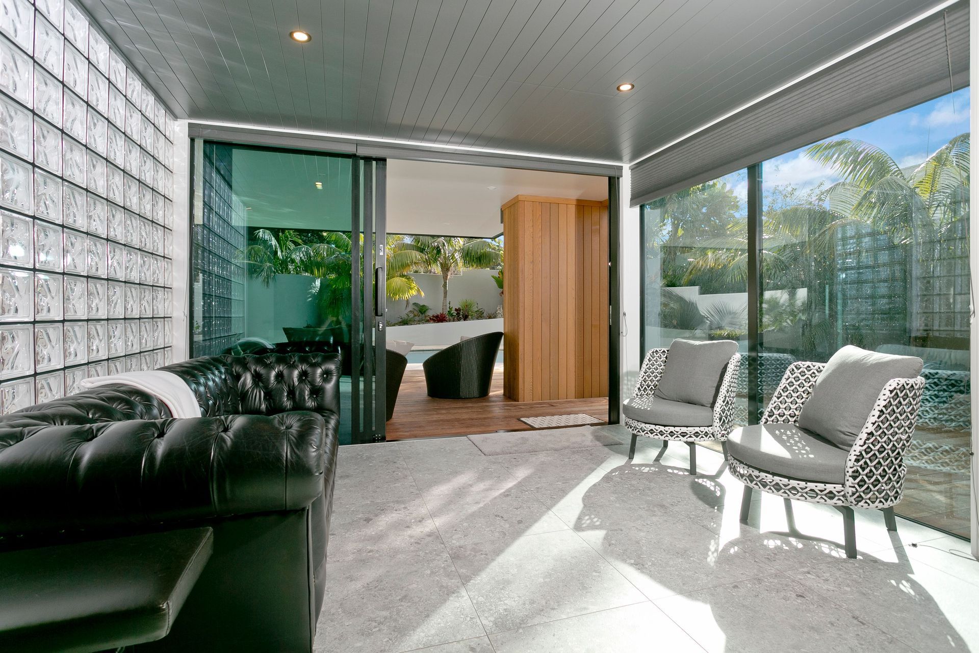 Off the entrance foyer, a further living area leads onto the refurbished deck area and swimming pool.