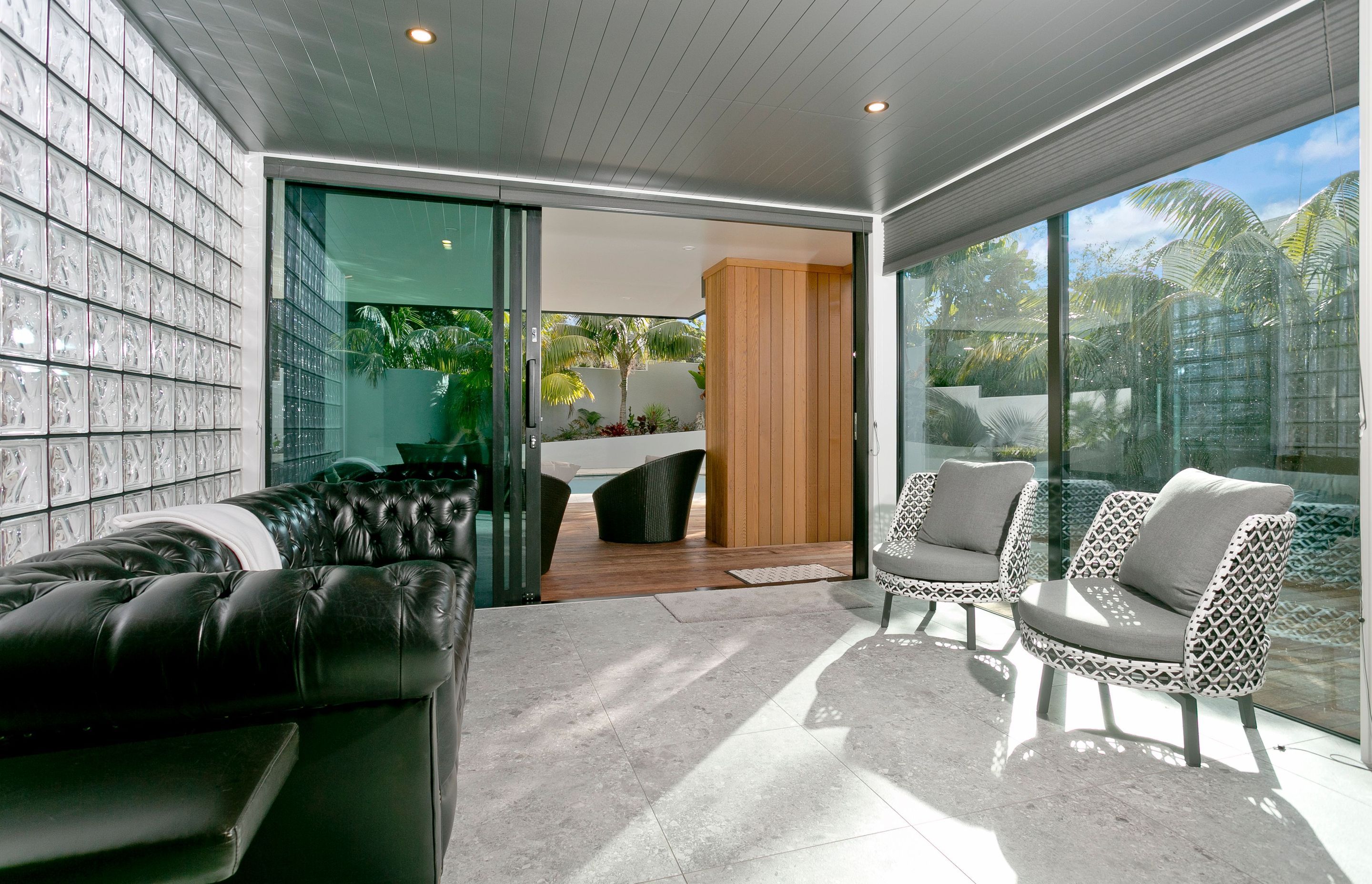 Off the entrance foyer, a further living area leads onto the refurbished deck area and swimming pool.