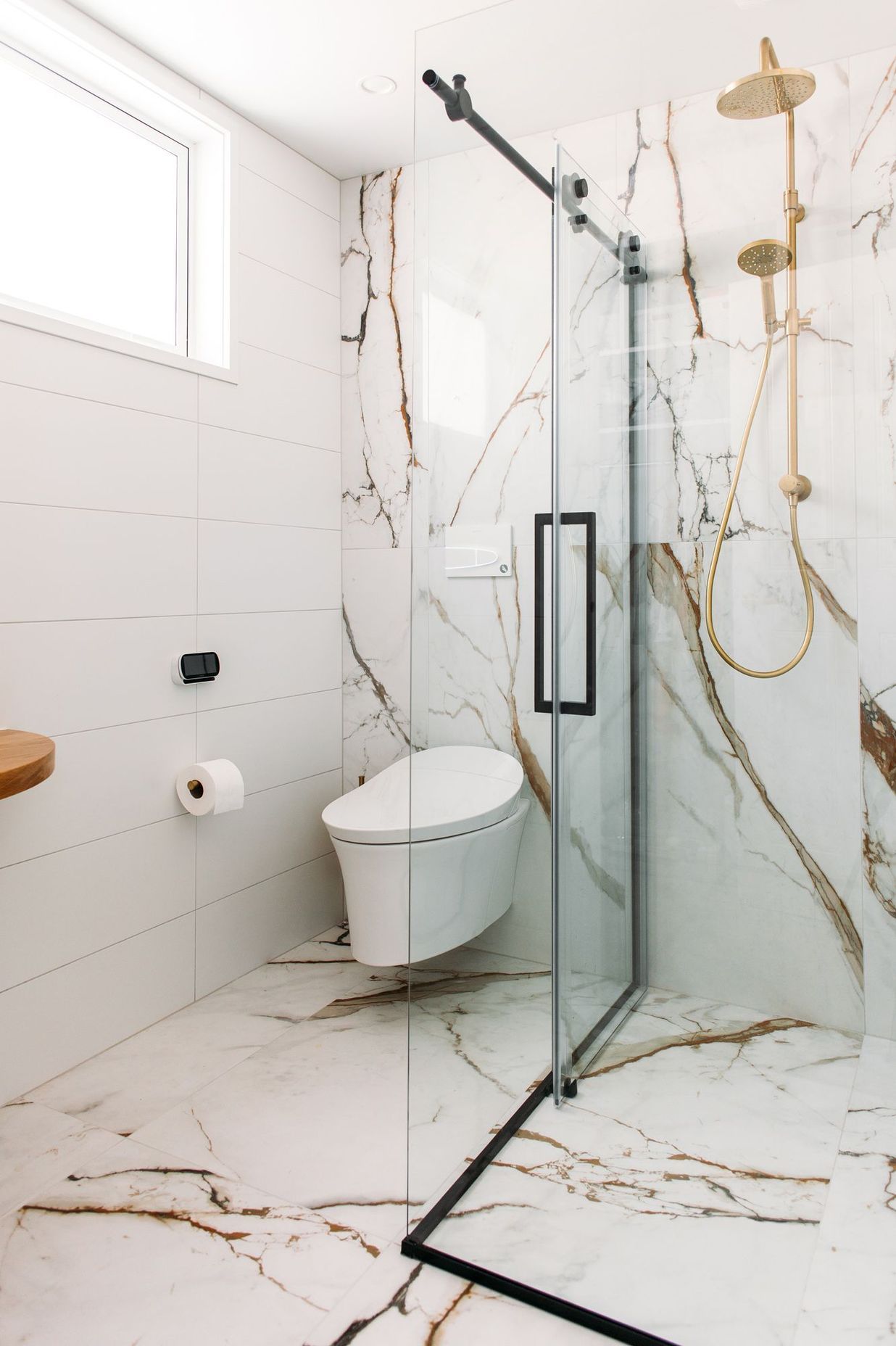 A wall hung smart toilet fit the brief in this tiled bathroom.