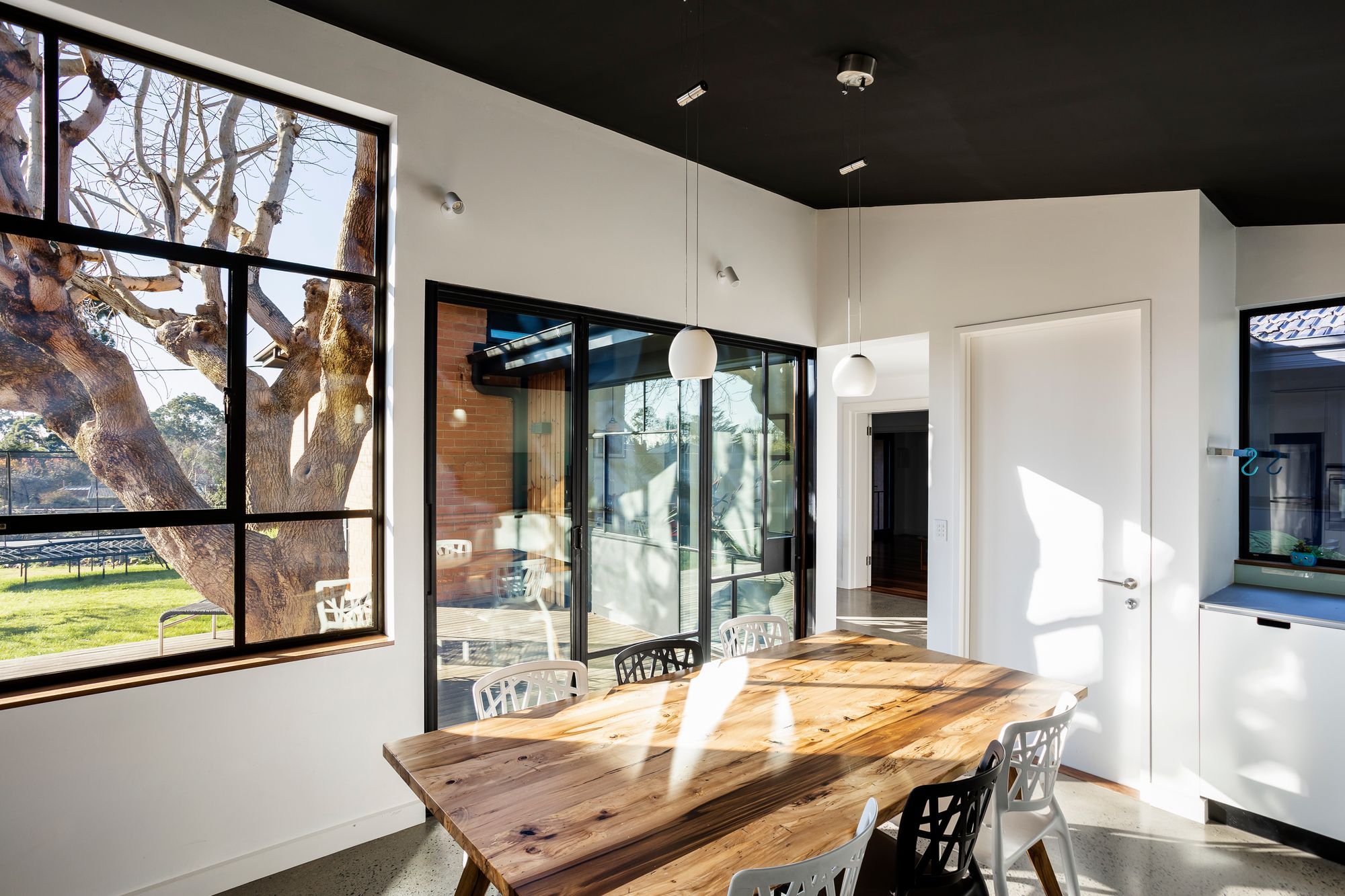 The kitchen now faces the garden and is shaded in summer by the large tree in the deck