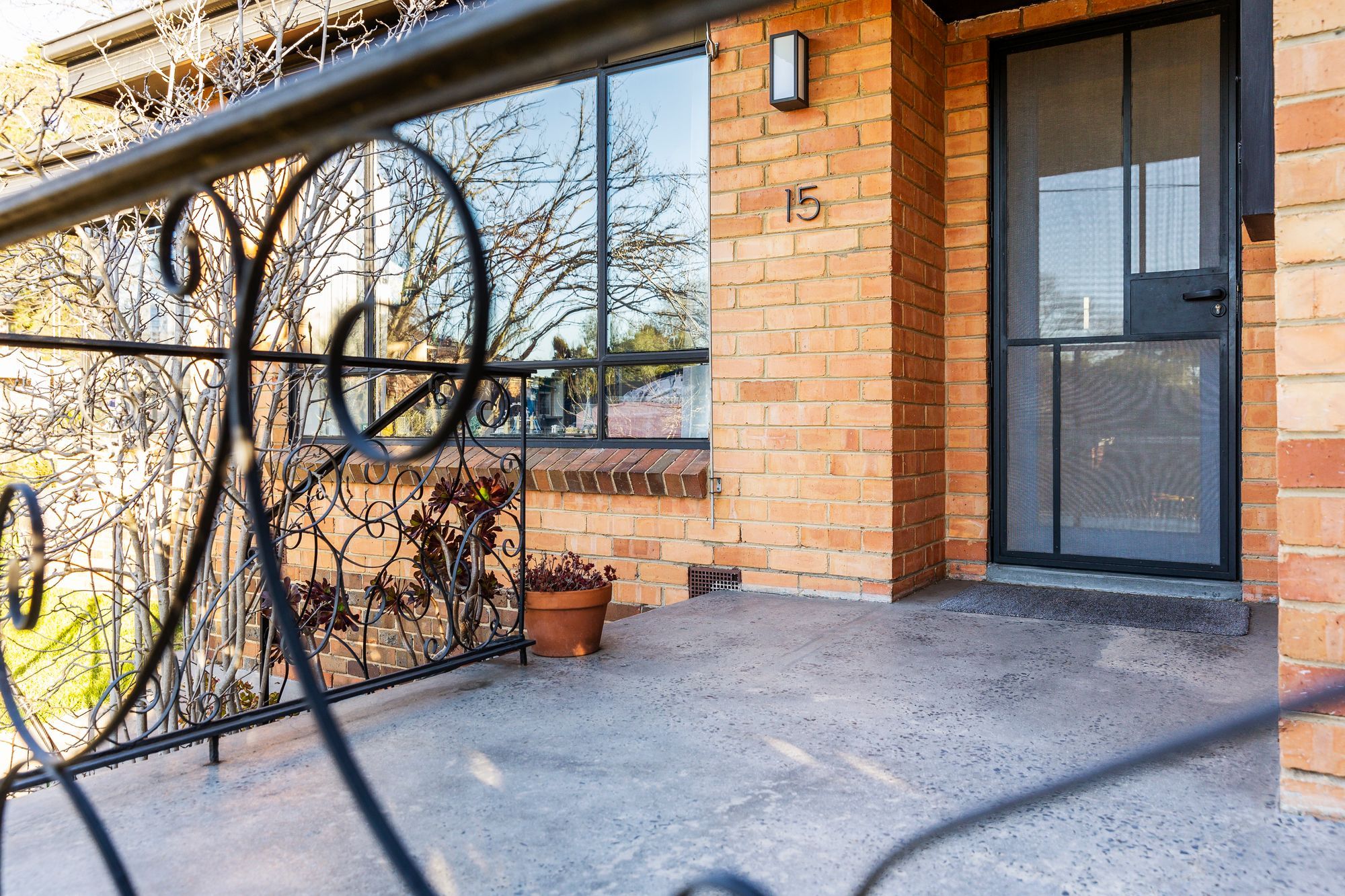 Restored entry porch with security door to matching window details