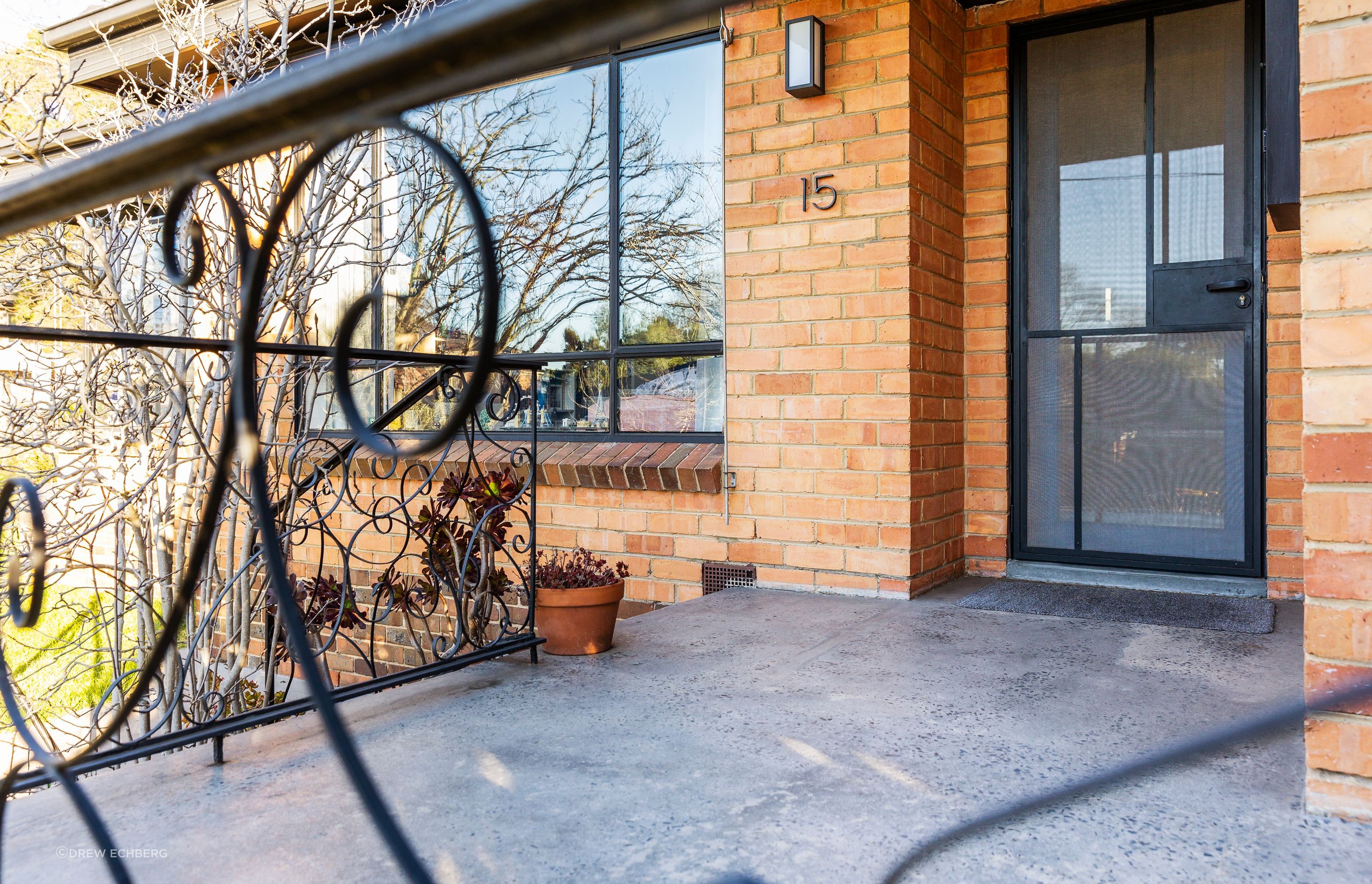 Restored entry porch with security door to matching window details