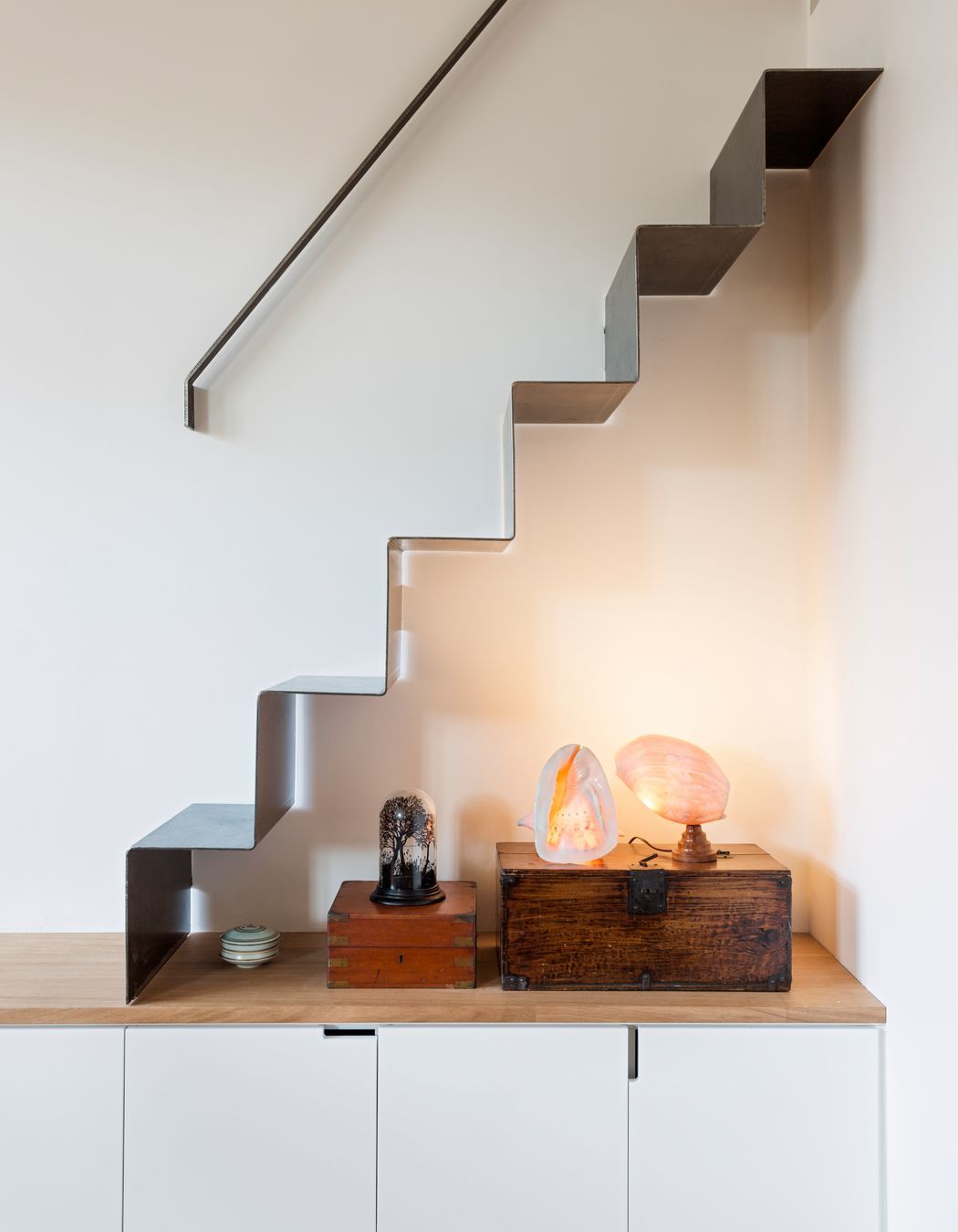 A folded metal stair gives good access to a storage area