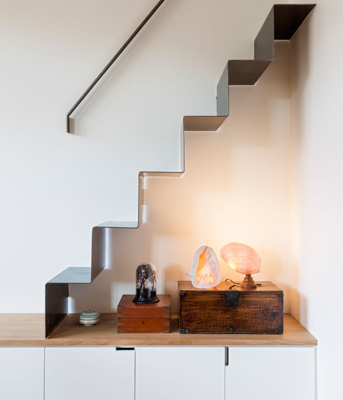 A folded metal stair gives good access to a storage area