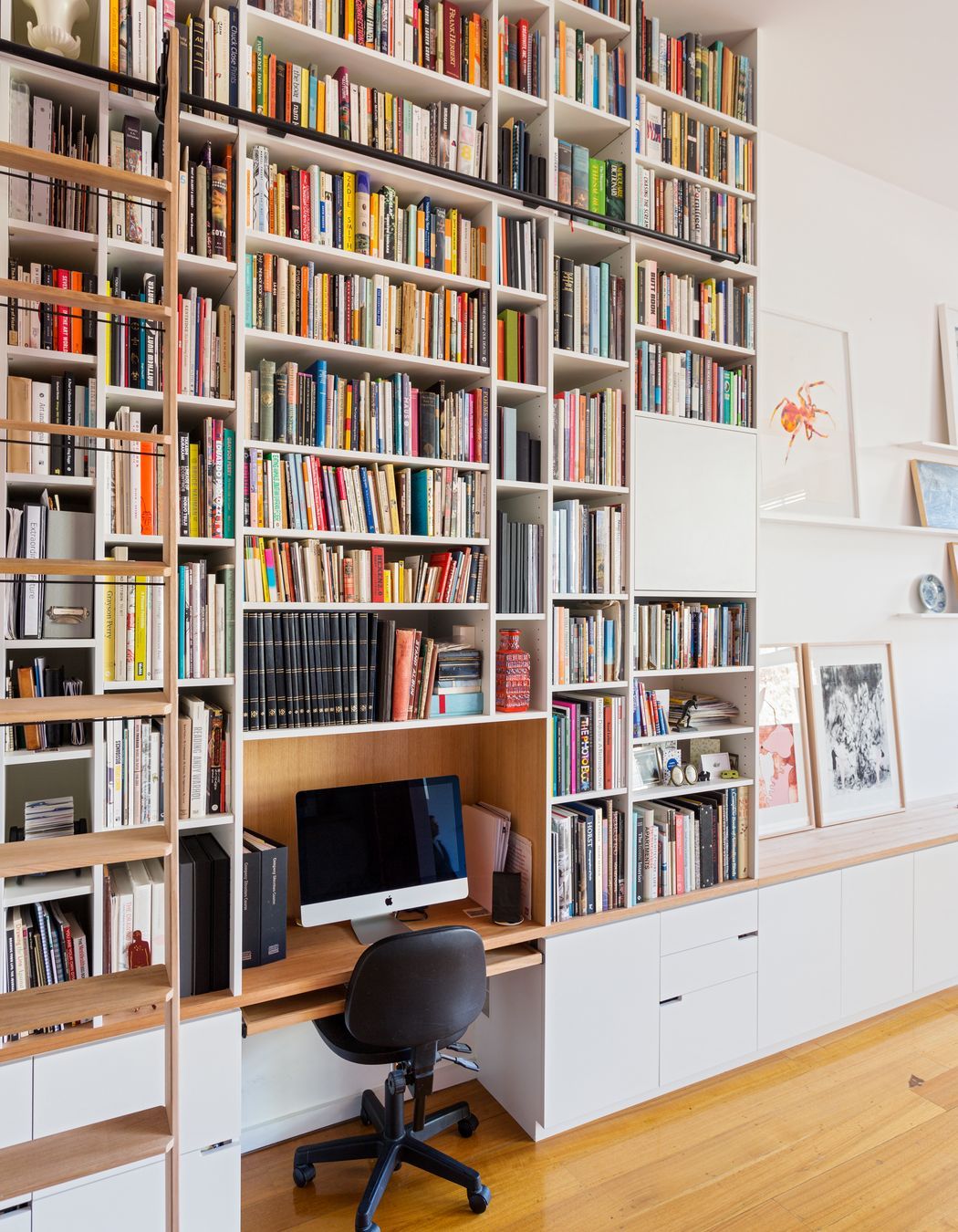 The library has a rolling ladder to access the books right up to the ceiling