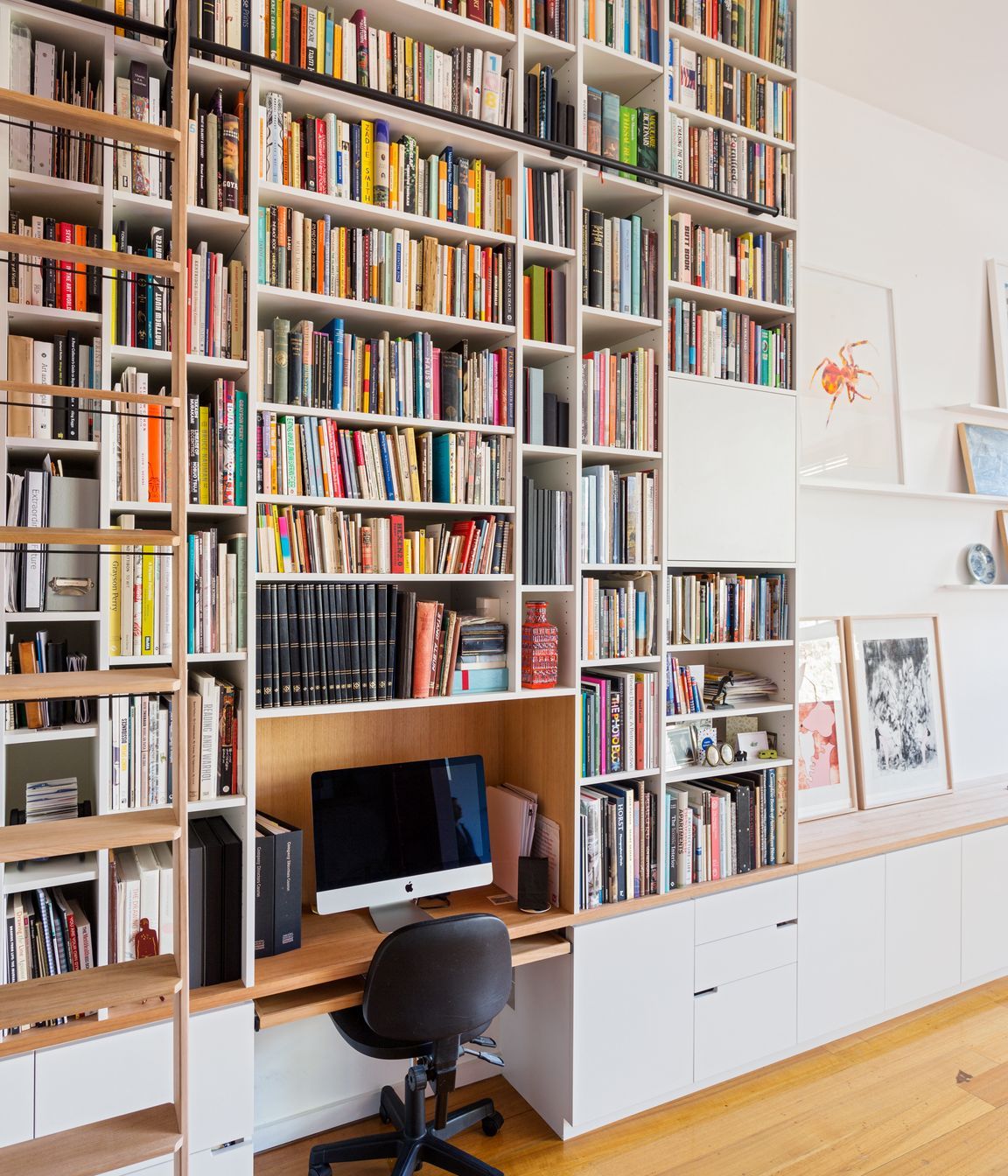 The library has a rolling ladder to access the books right up to the ceiling