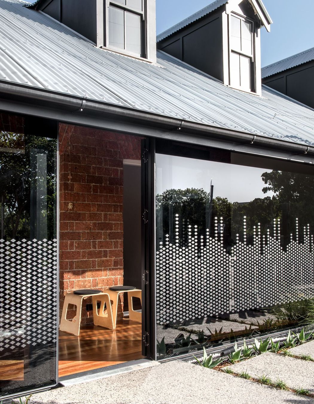 Photography: Cathy Schusler | The privacy glazing graphics take reference to the heritage building ornaments and create a playful pattern in the morning sun.
