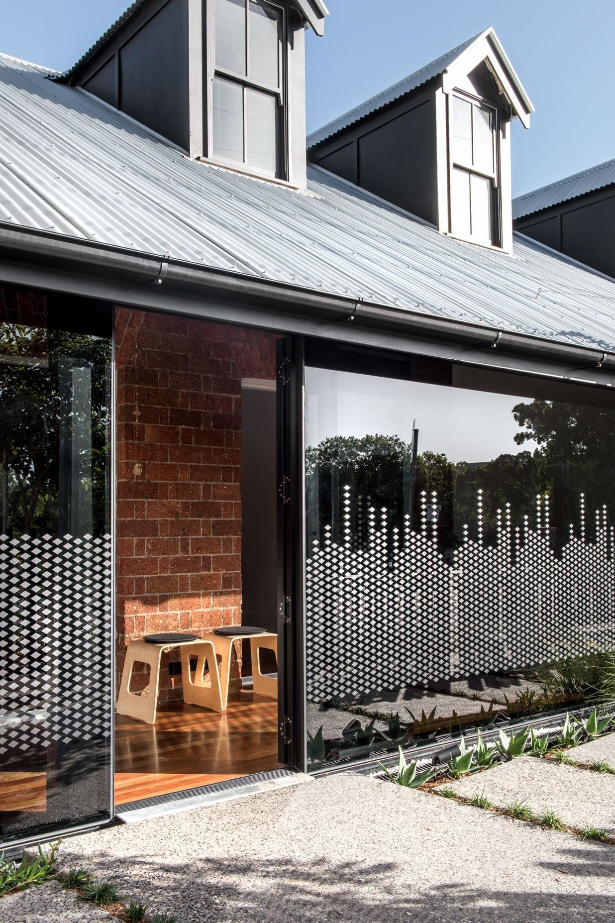 Photography: Cathy Schusler | The privacy glazing graphics take reference to the heritage building ornaments and create a playful pattern in the morning sun.