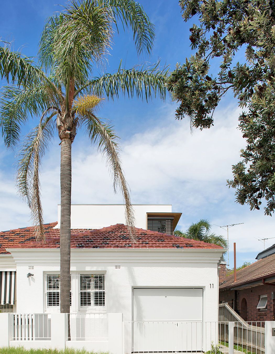 Street view with the second storey addition sitting discreetly behind the existing roof line.