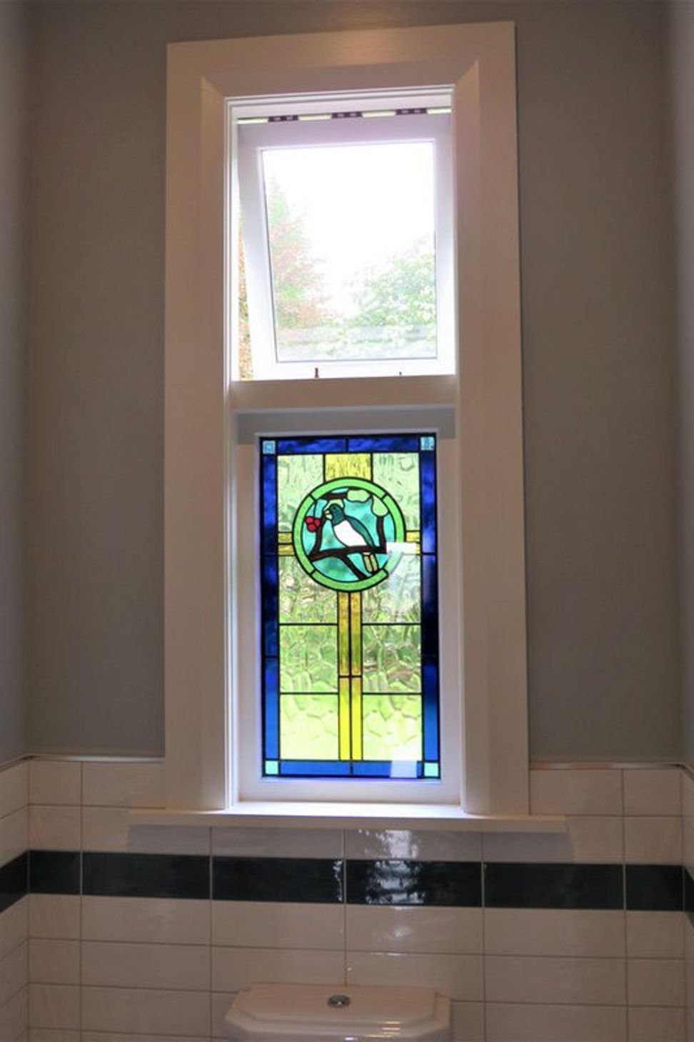 Stained glass window with wooden sashes
