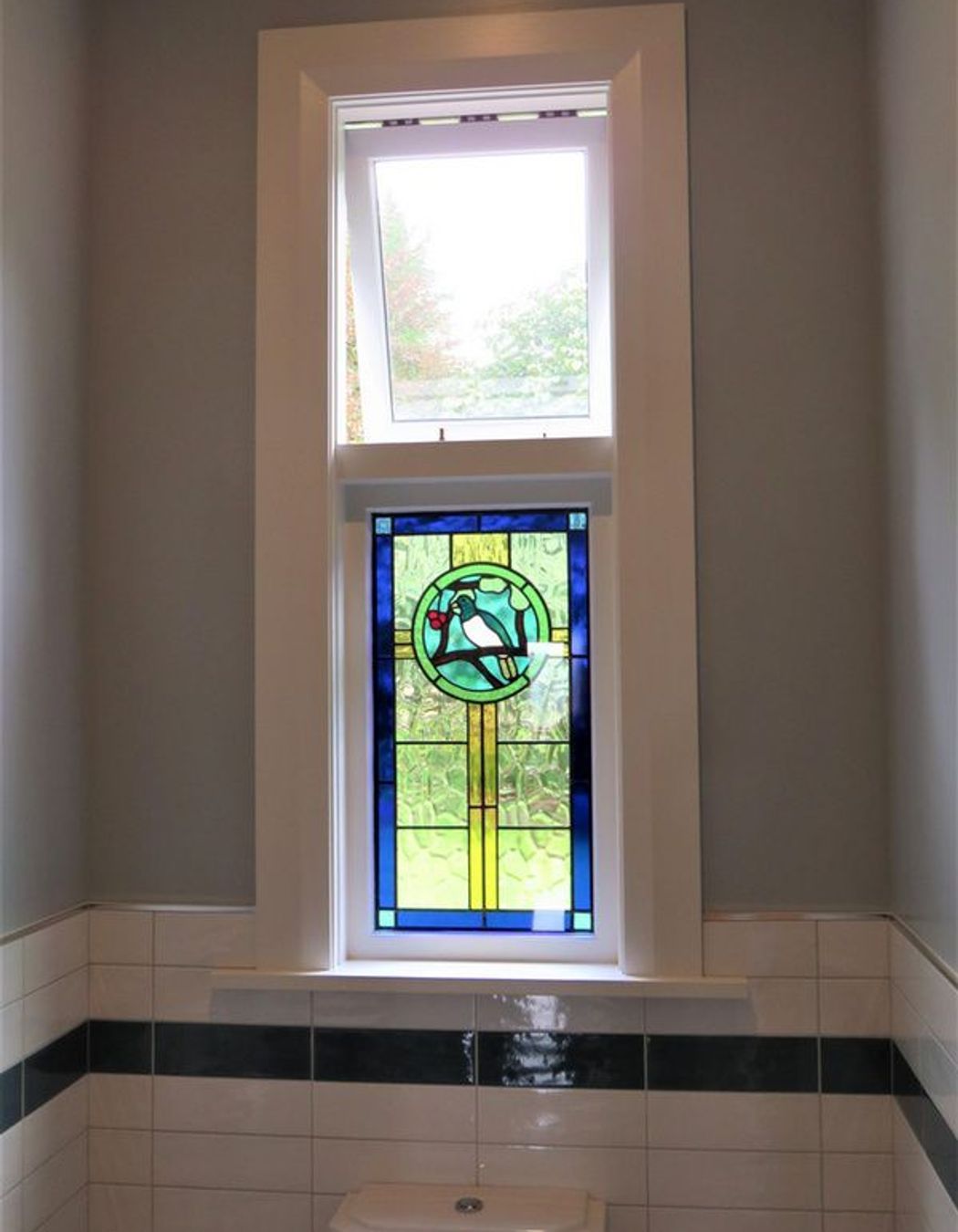 Stained glass window with wooden sashes