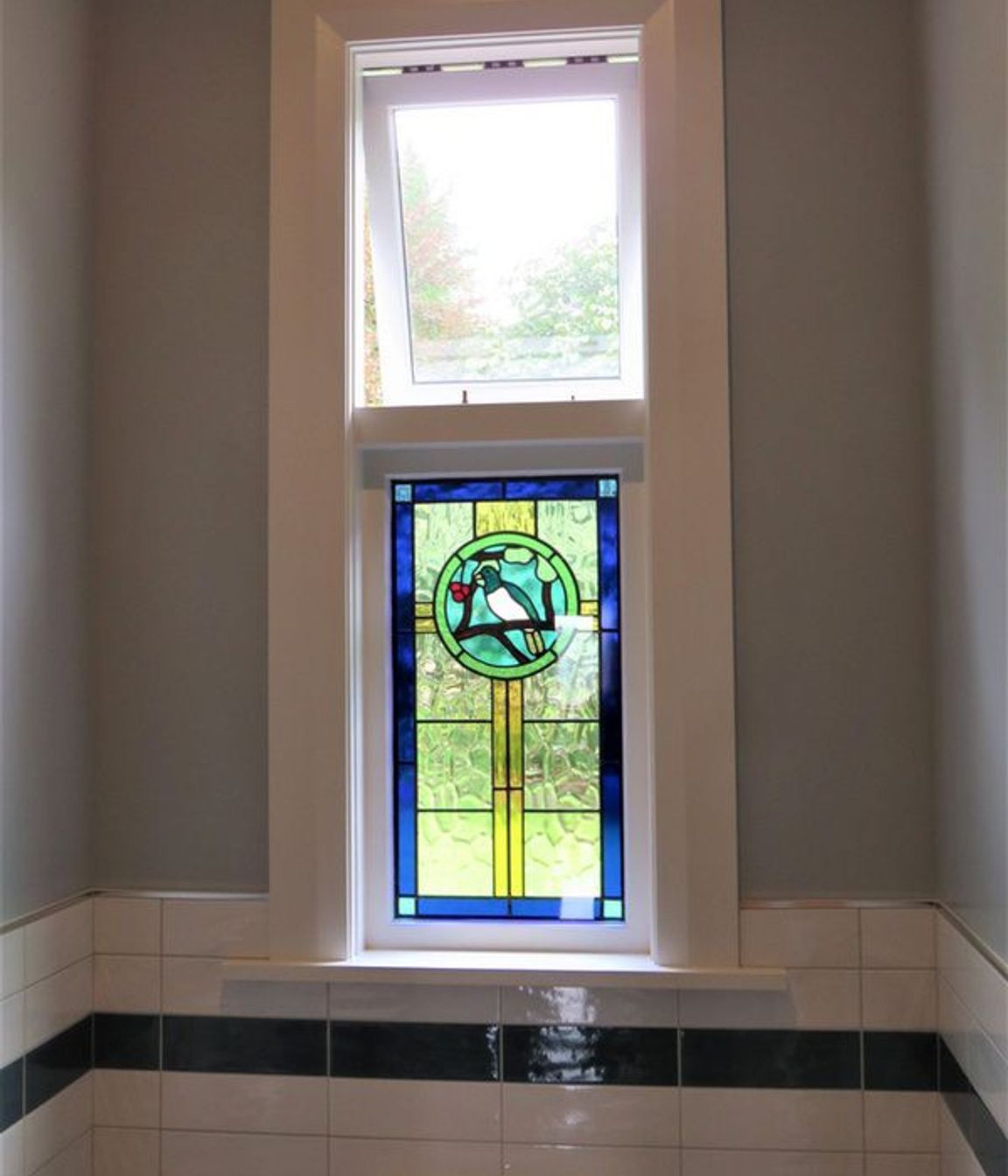Stained glass window with wooden sashes