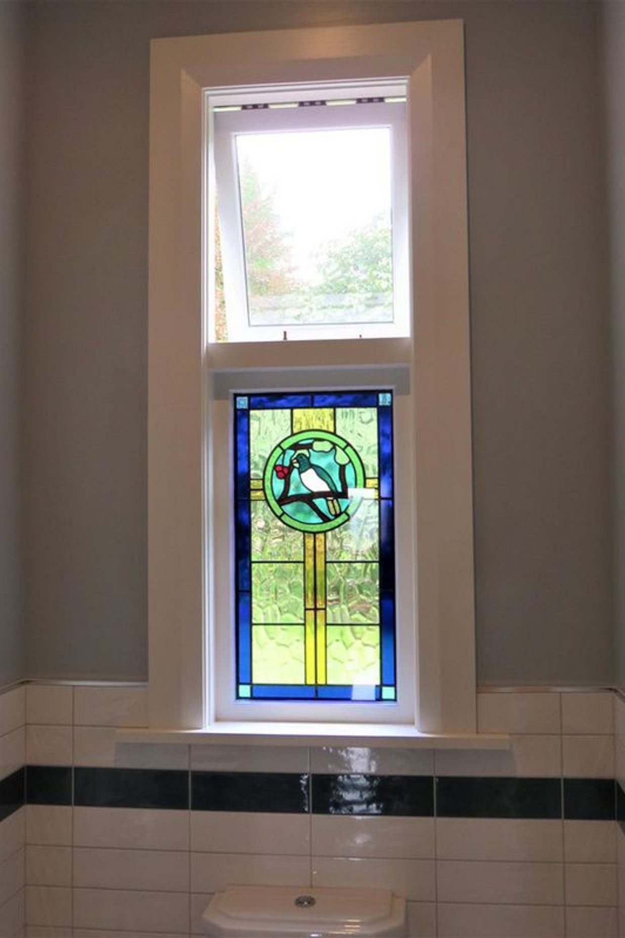 Stained glass window with wooden sashes