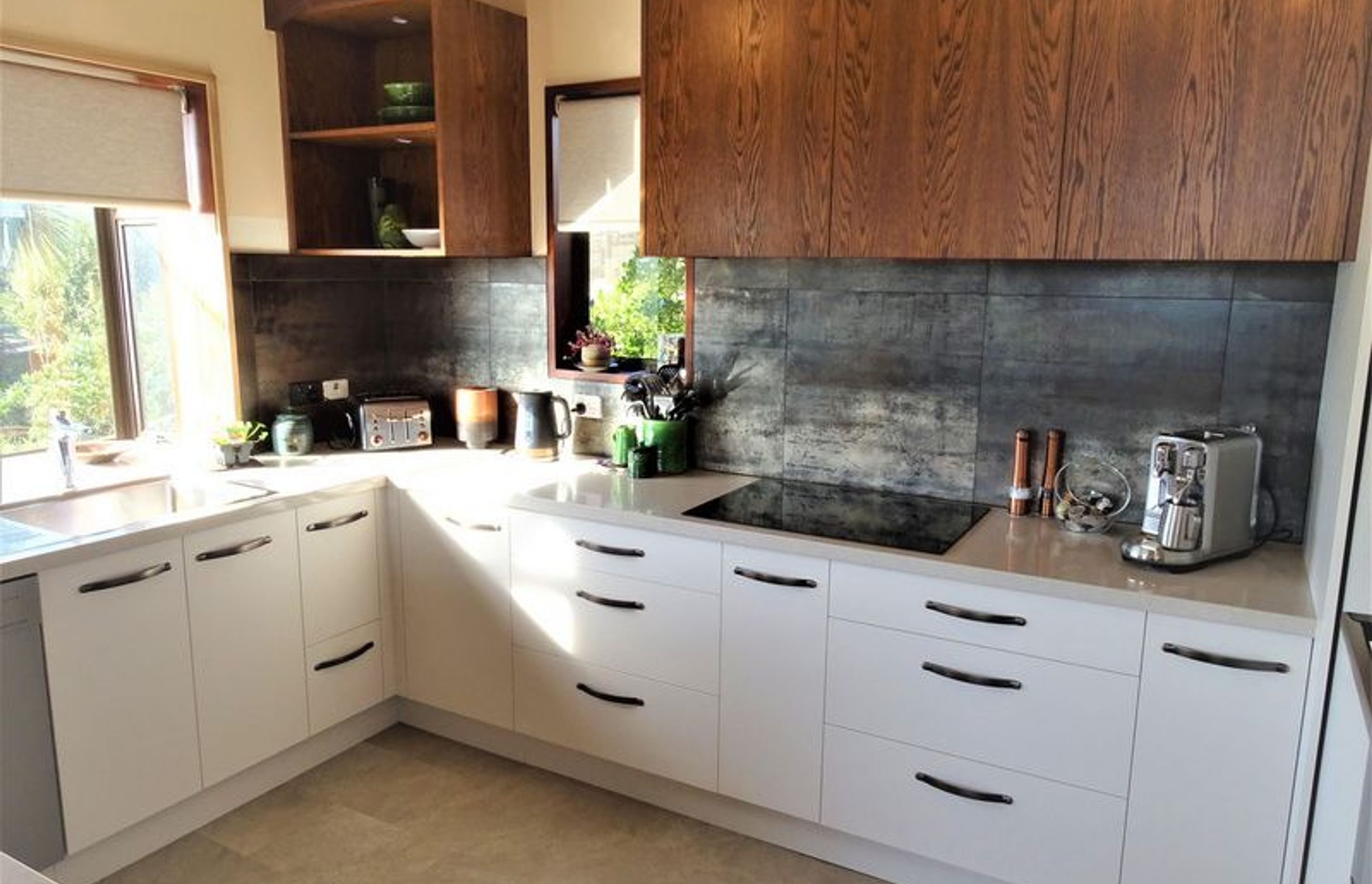 The kitchen joinery from the storage to the window and ceiling joists all ties together